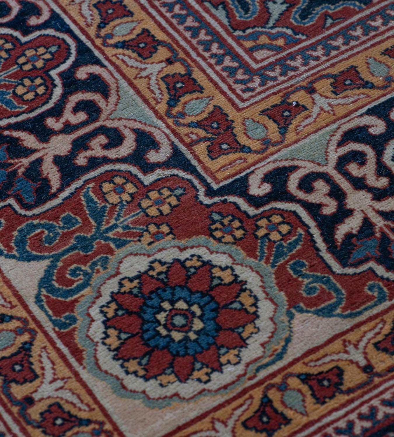 This traditional hand-woven Persian Tabriz rug has a shaded indigo overall field of rosette pendants issuing stylized cusped lozenge forming matrix, each panel enclosing a radiating arabesque floral motif, in an elegant reciprocal indigo and