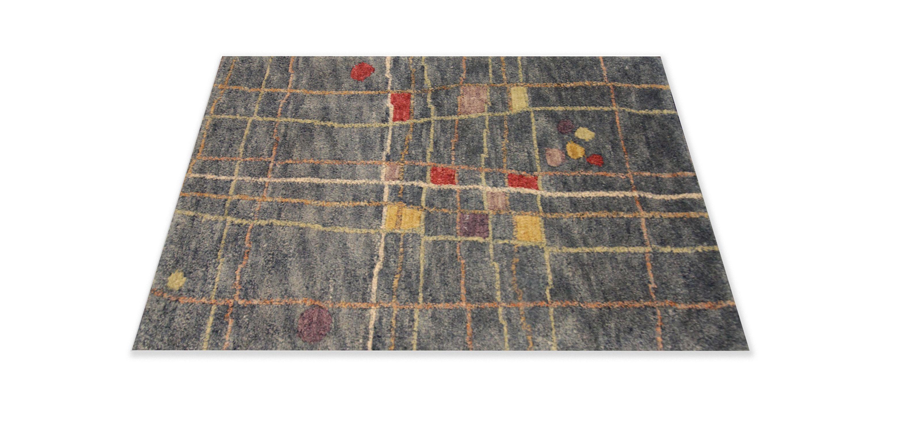 This fine wool mat is the perfect front or back door accessory. Woven by hand with fine wool and cotton that has been dyed with organic vegetable dyeing techniques. The design features a modern abstract design with accents of red, yellow and green