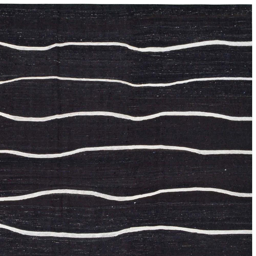 21st Century Handwoven Contemporary Black and White Kilim Carpet

This is a flat-weave Kilim from western part of Turkey, woven with vintage wool and goat hair, intended as an everyday floor cover.
Modern designs are often based on traditional