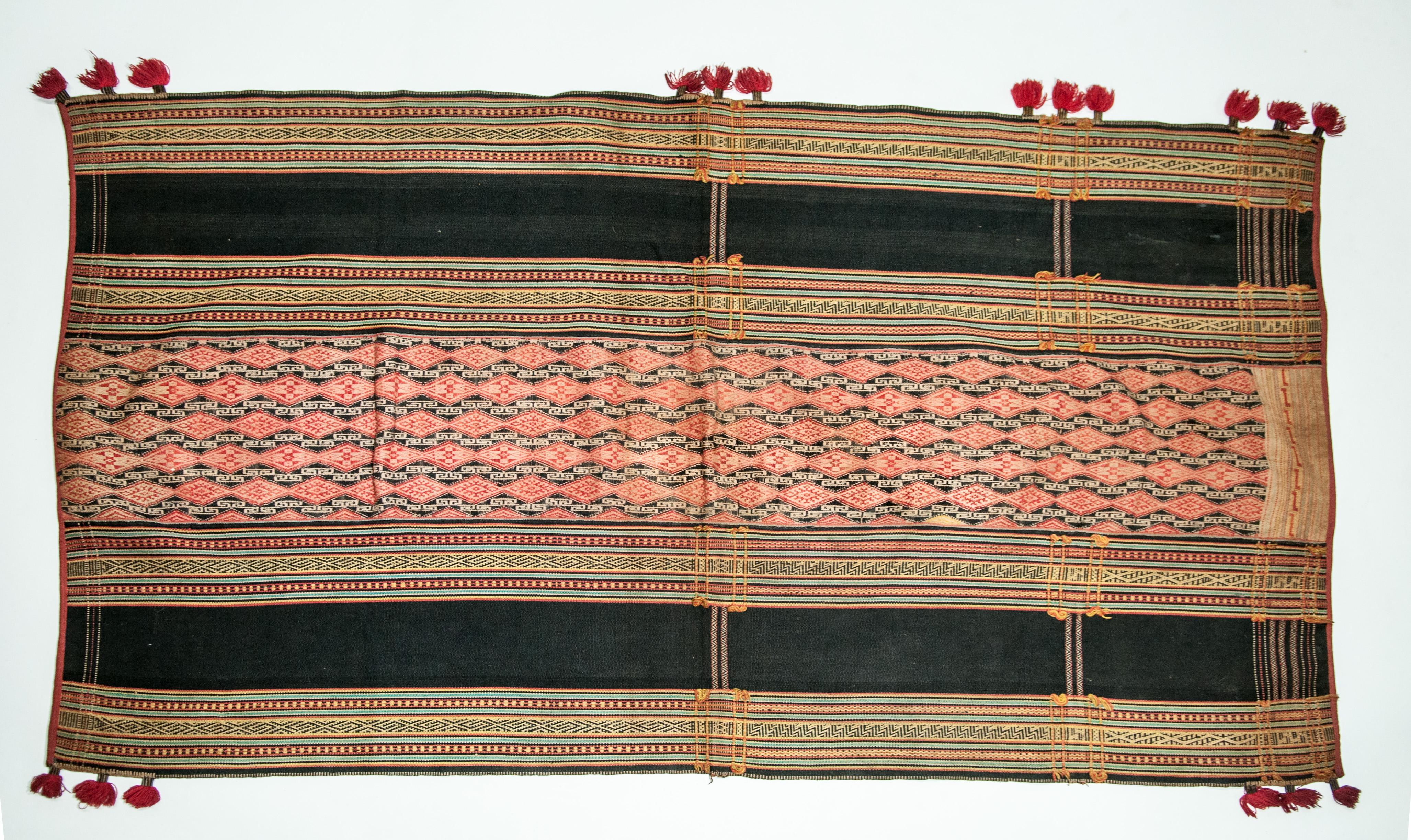 Mid-20th century cotton skirt from the Maa or possibly X'tieng People of Lam Dong Province, Central Highlands, Vietnam.
This sarong comprises three panels, each woven on a traditional backstrap loom and then sewn together. It showcases detailed