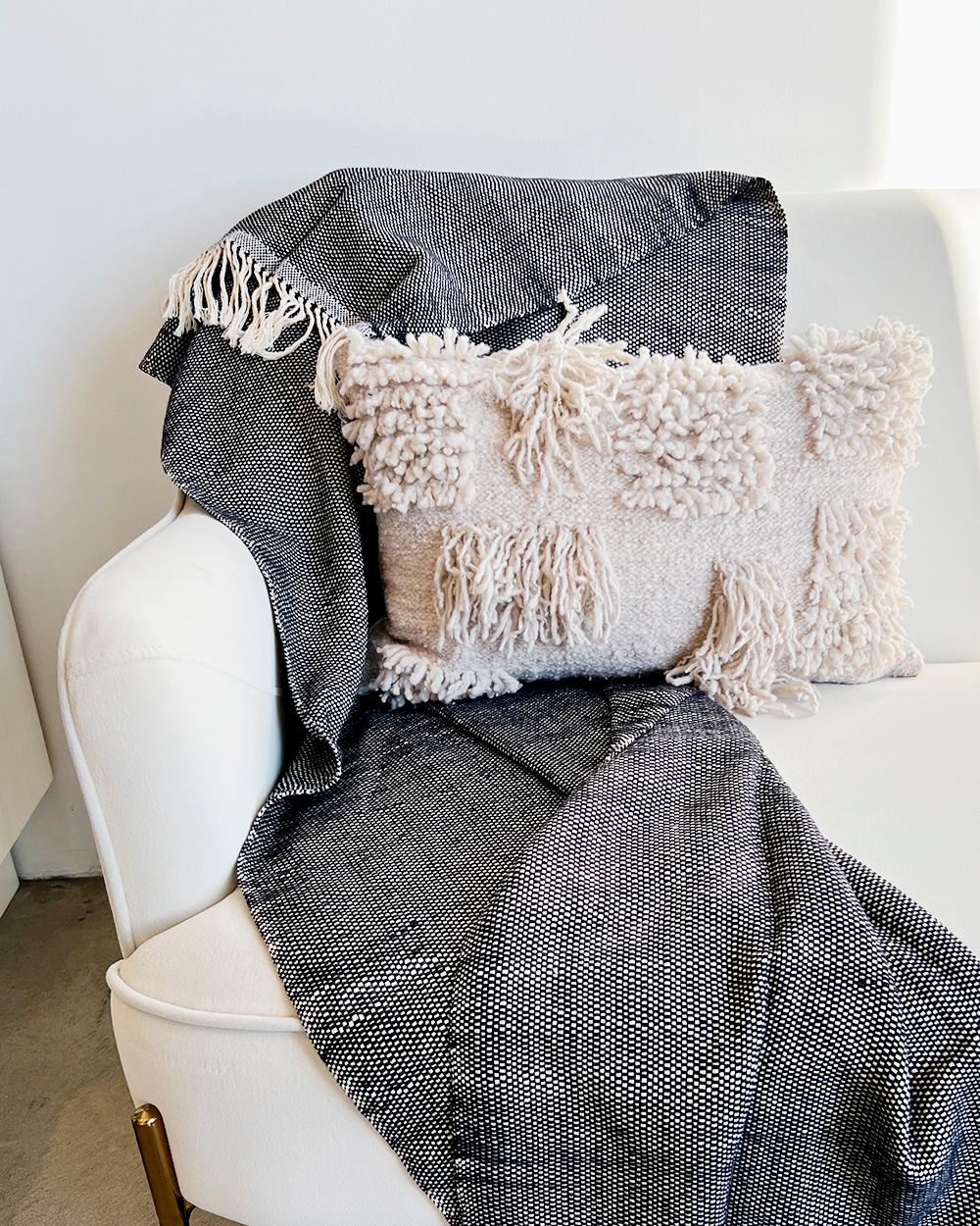 A crisp throw for your living room
Cuddle up in the cozy comfort of this luxe and lightweight Amano Throw. Crafted from organic cotton, its soft white and navy check weave design is sure to add a modern, minimalist flair to your space. With a crisp