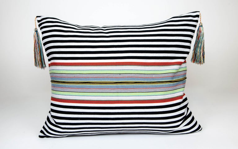 These delightful pillows are made in the Nachig municipality of Zinacantan, Mexico, an area that has been characterized by their finely woven striped ponchos and huipiles, these pillows are created on back strap looms using age old methods and out