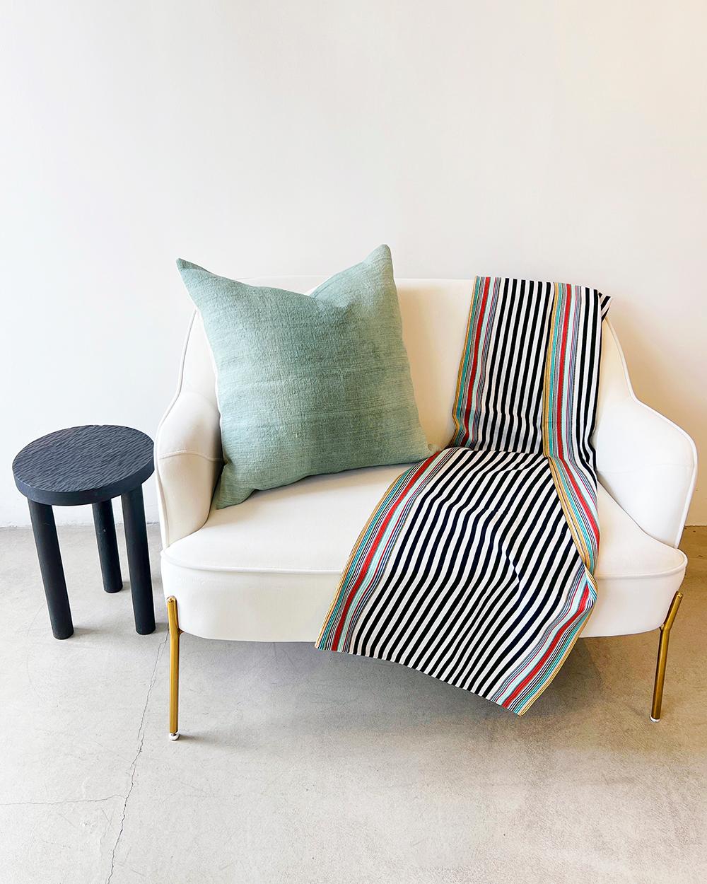 This SanCri Cotton Throw is a unique and vibrant addition to any home decor. Handmade with 100% cotton in Mexico, the bold black and green stripes will bring warmth and comfort to any living space. Make a statement while staying cozy with this