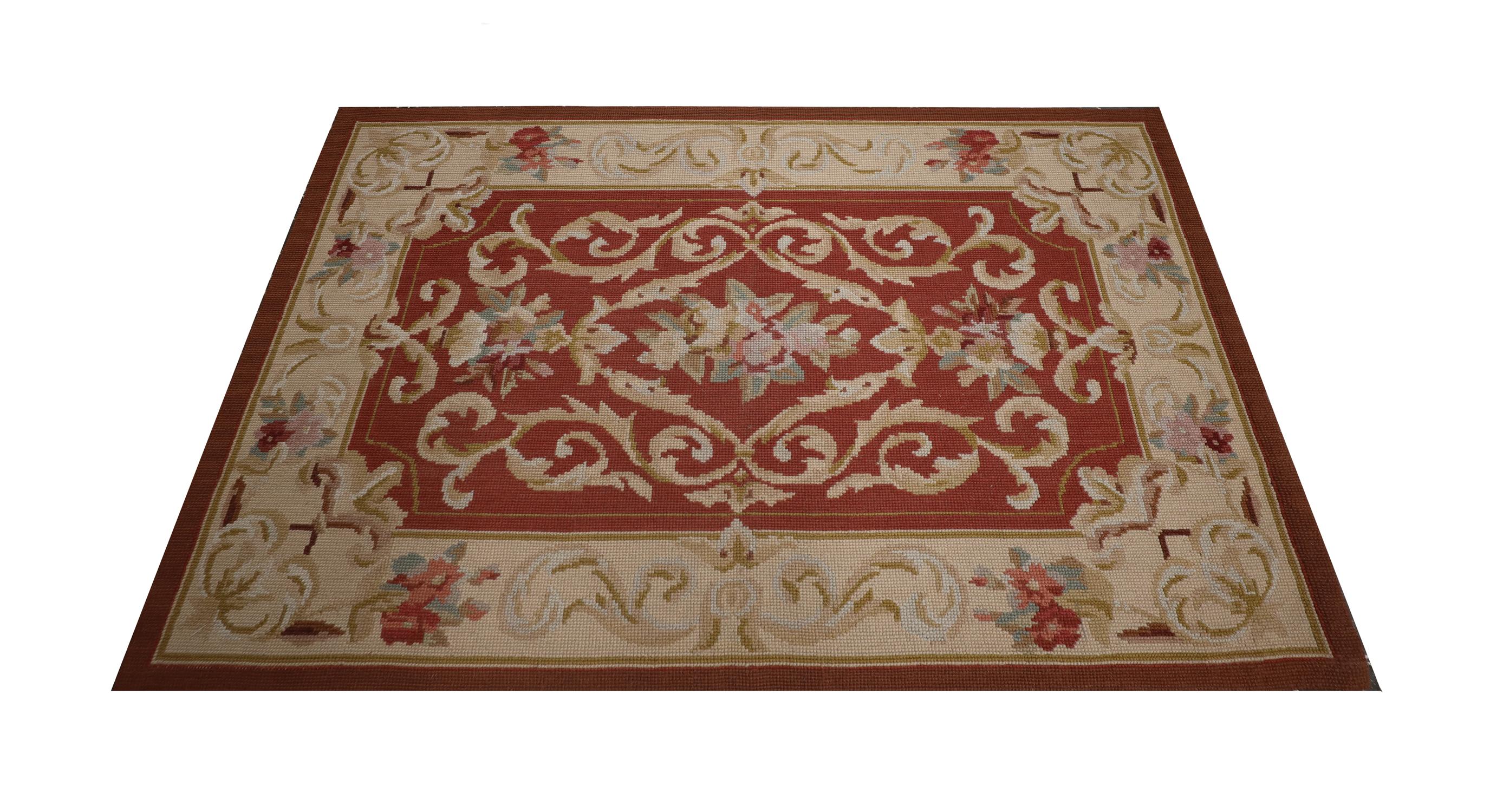 Red and beige accent colours make up the main palette of this elegant needlepoint. Woven with a symmetrical foliate design that has been intricately woven with flowers winding throughout. The design and colour palette featured in this piece make it