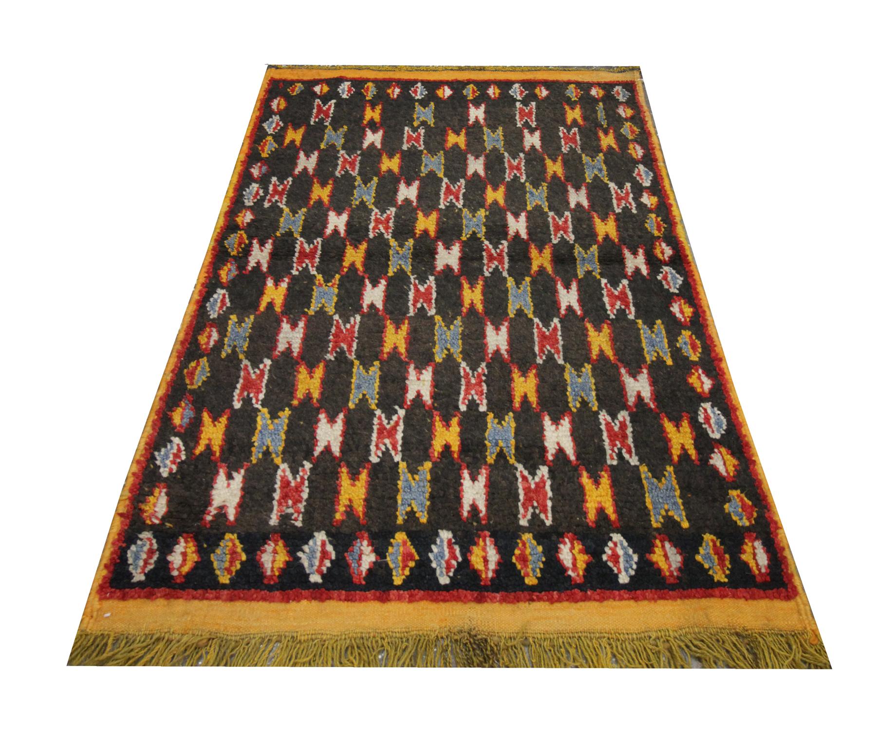 This fine wool rug was woven by hand in the 1960s with a geometric repeating all-over pattern. The colour palette is bold with yellow, red, ivory and blue accents. Paired with the simple geometric design, this piece is sure to make the perfect