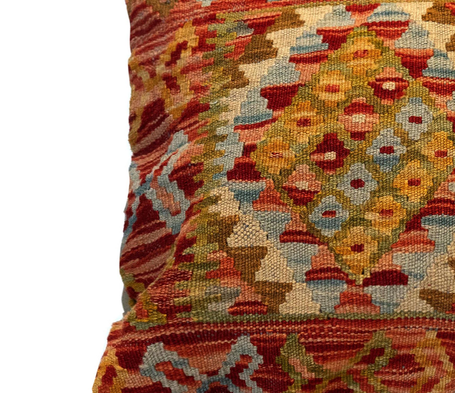 This unique geometric cushion cover is a handwoven kilim cushion cover woven in Afghanistan in the late 20th century/ early 21st century. Woven with the traditional Flat Woven kilim technique with a bold geometric design. Featuring a rustic colour