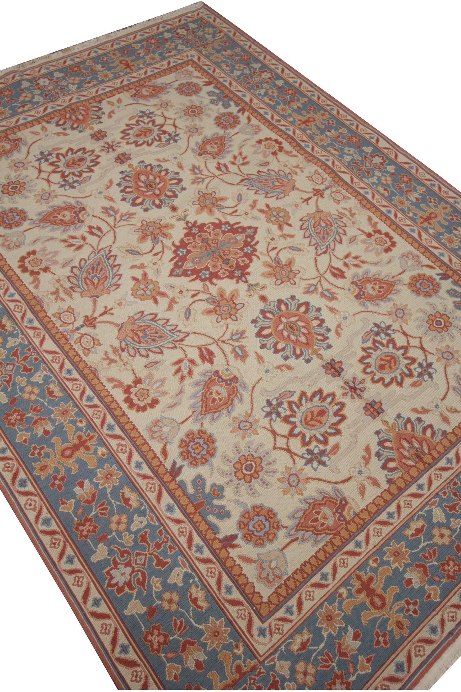 This elegant flat woven Soumak rug is a traditional piece woven by hand in the early 2000s in Afghanistan. This piece has never been used and is in excellent condition. The design has been woven with a subtle cream background with red, blue, and