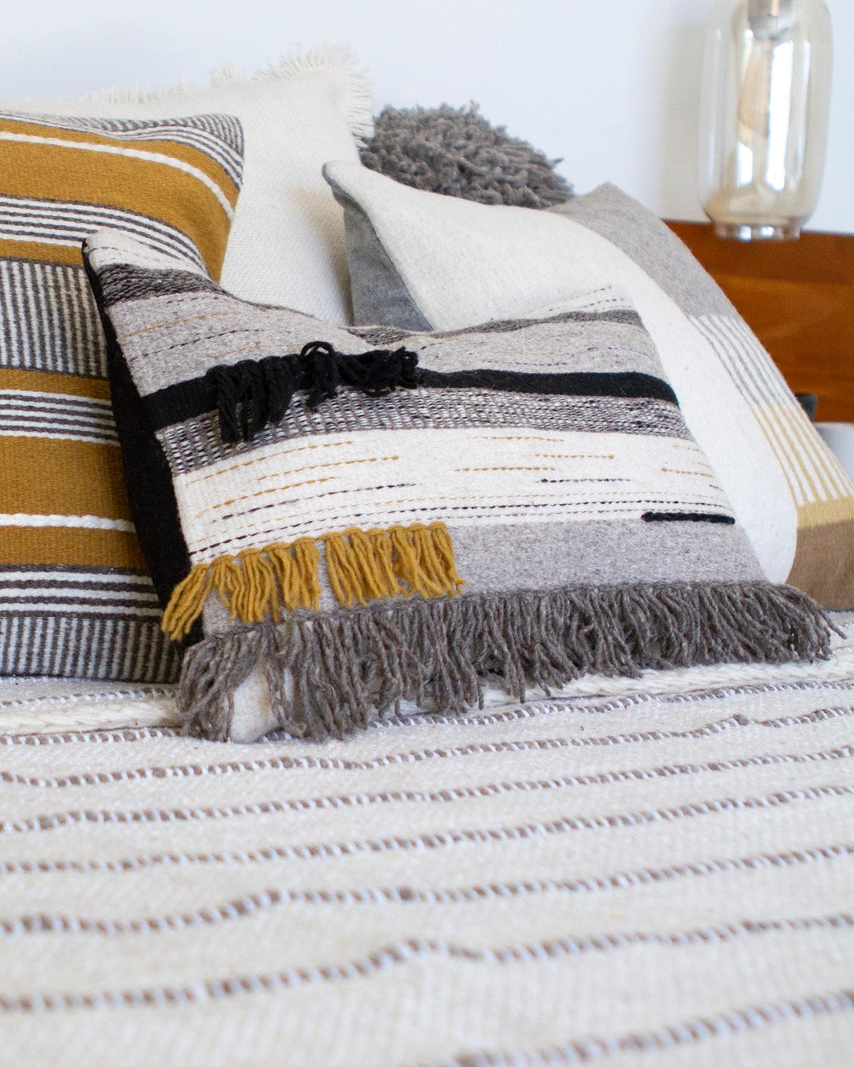 Artisanal Wool Gray Striped Cushion

If you’re looking to add a distinct pop of graphic pattern to your home’s living spaces, our handcrafted throw pillows are the perfect option. Designed by talented artisans from Oaxaca, Mexico. Every decorative