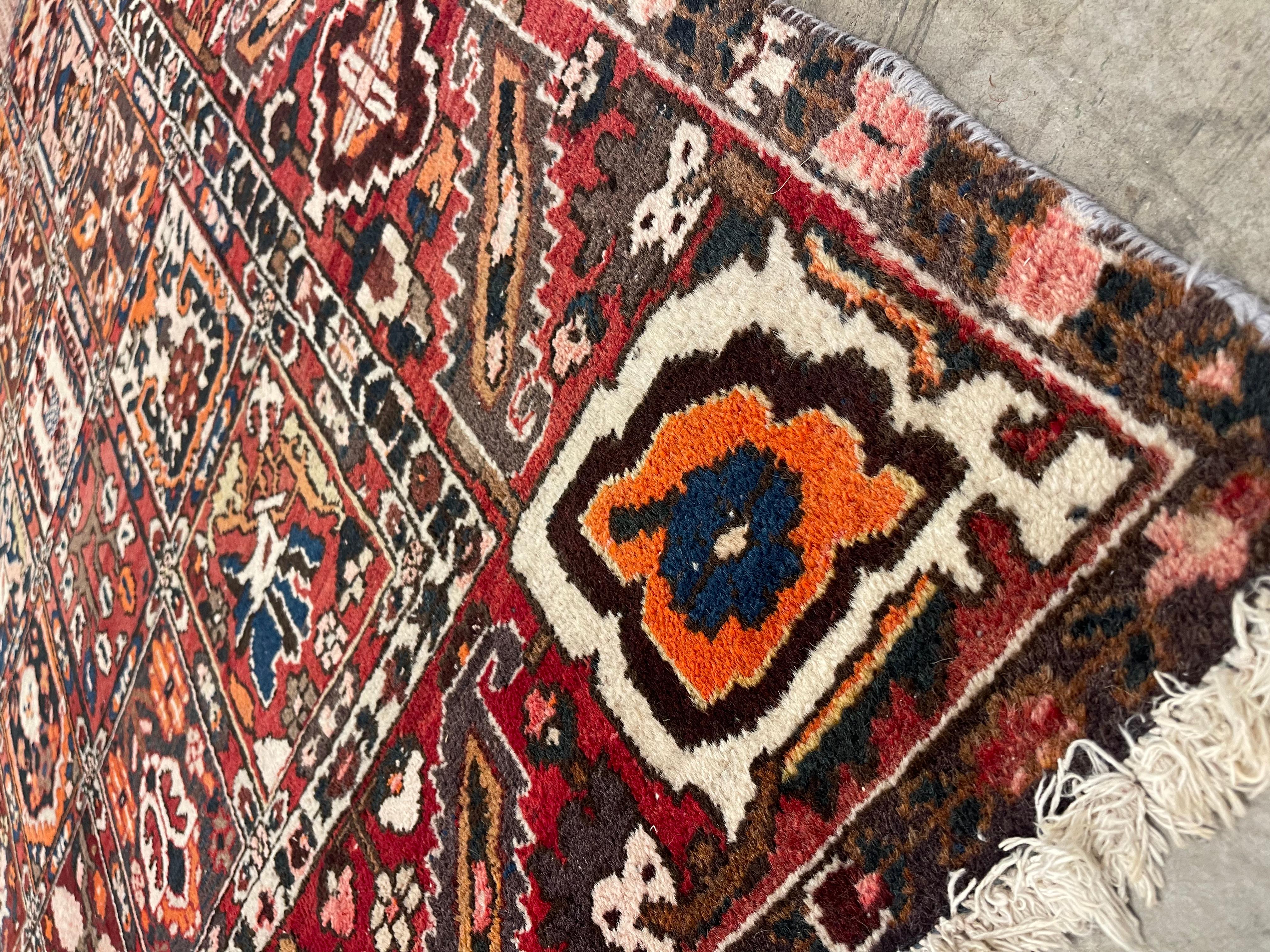 A mid-20th century Persian Bakhtiari rug.  This piece features the classic Khesti design—an intricate grid of individually patterned compartments, each filled with stylized floral motifs, geometric forms, and tribal symbols. The saturated palette,