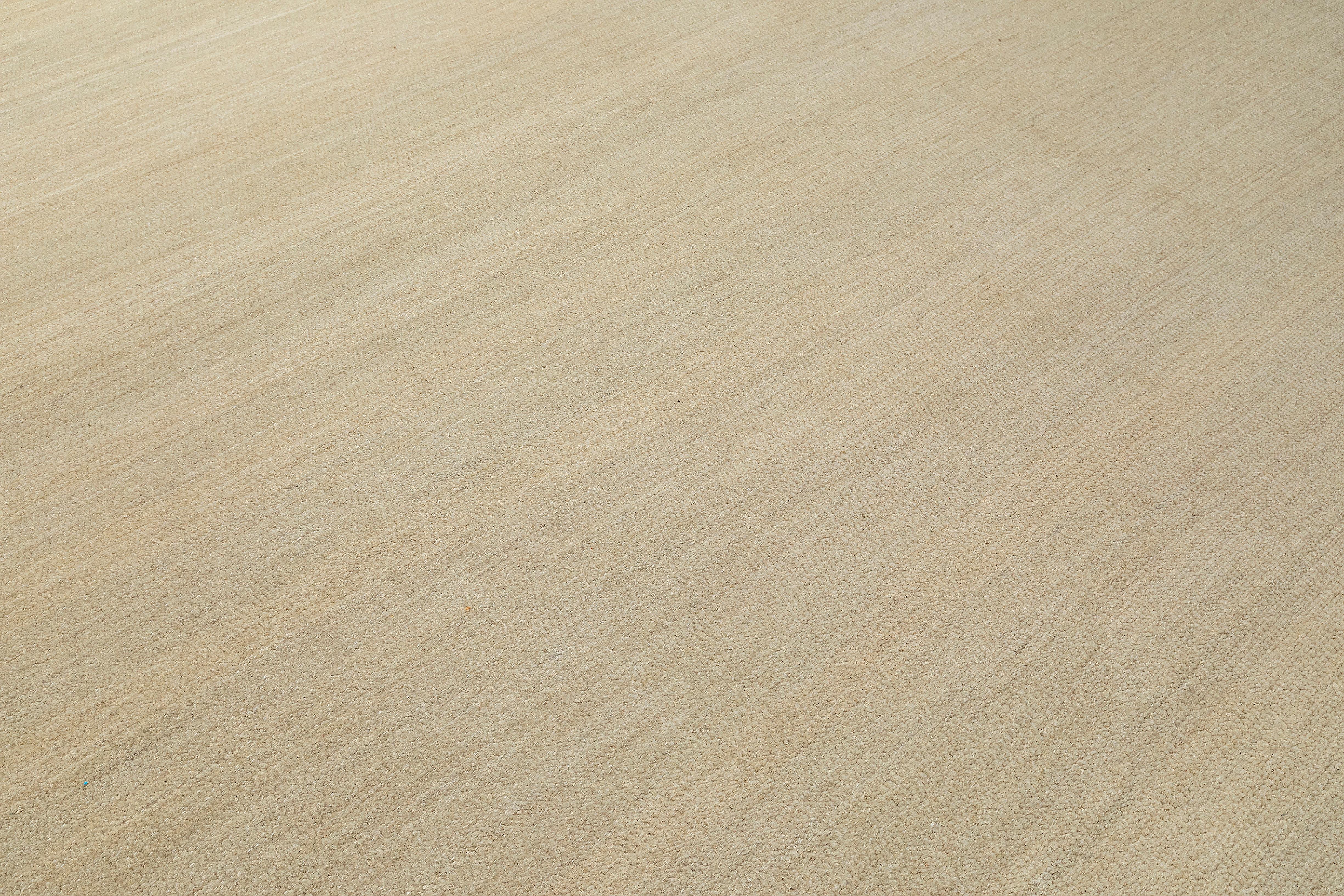 This handcrafted Persian Shiraz rug is woven from hand-spun wool and dyed with natural vegetable pigments, creating a warm, organic aesthetic. The subtle neutral tones and understated design exude minimalist elegance, making it a versatile piece for