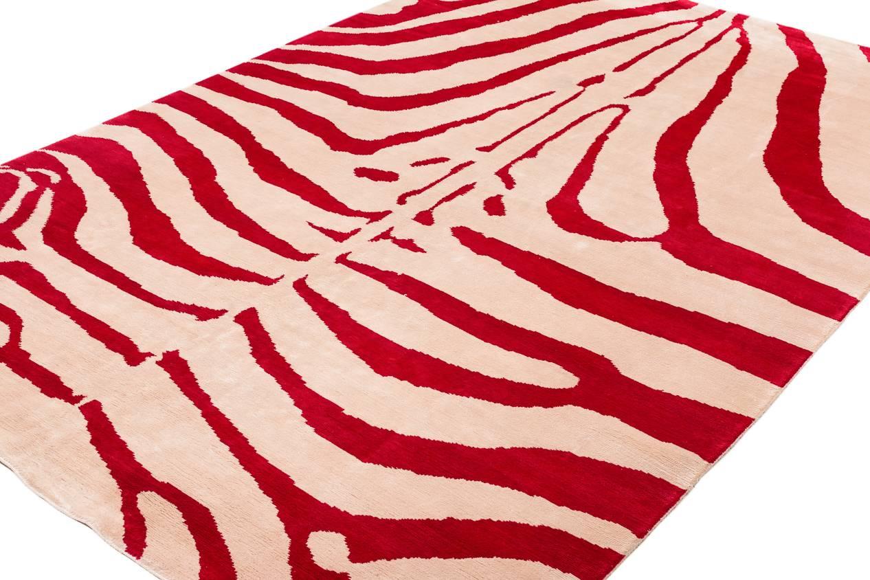 This silk zebra rug is one our original signature rugs. This one is woven in white and magenta-red silk.
