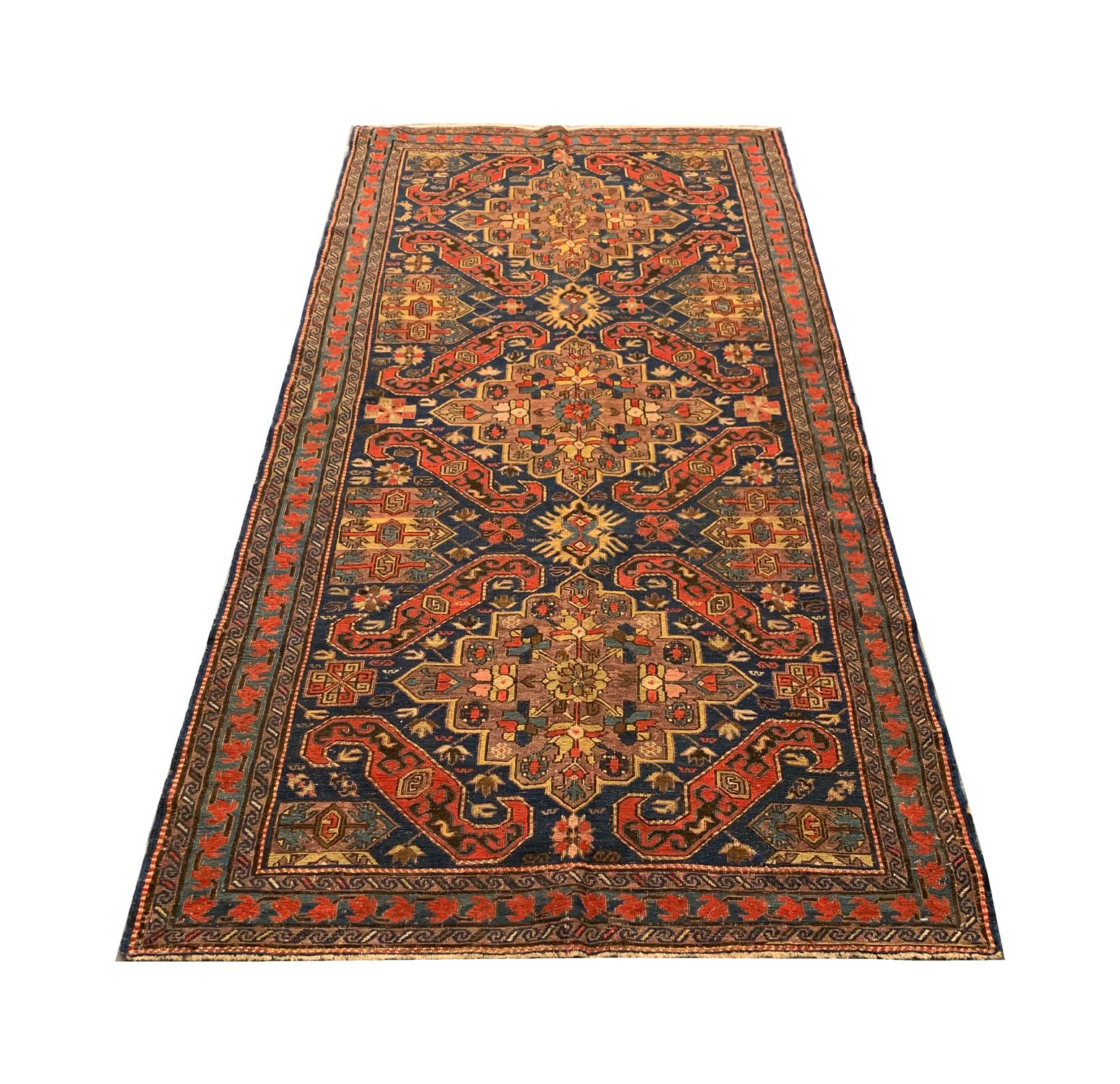 This fine wool rug is an excellent example of kilim Sumakh Caucasian rugs woven in the 1880s. The central design features a trio of large medallions woven on a deep blue background in cream, brown, orange, and blue accents. The colour and design in