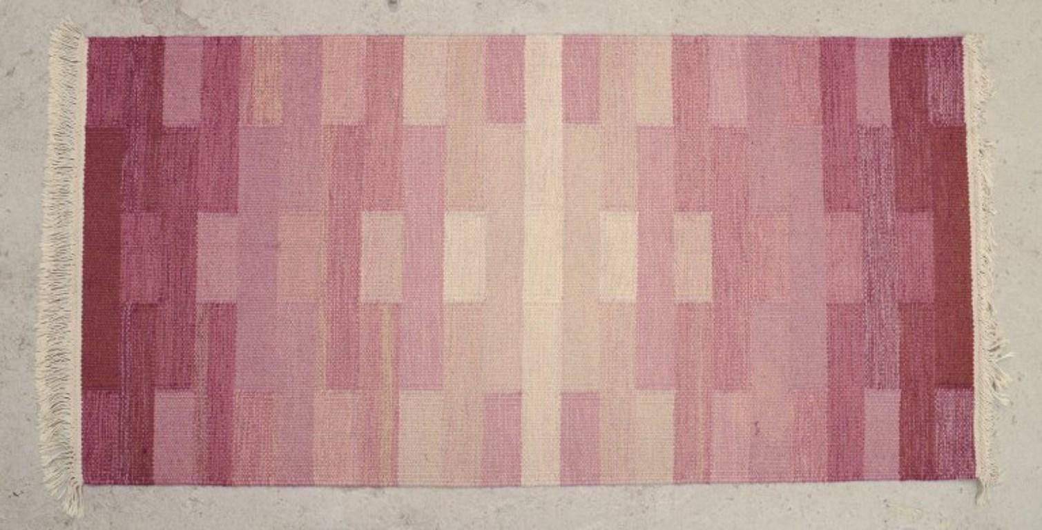 Pre-owned goods are exempt from import duties for U.S. customers. 
Therefore, no import tariffs will be applicable to your purchase.

Handwoven “Terass” rug in wool. Rölakan technique. 
Woven with geometric patterns in reddish and violet tones.
Ca.