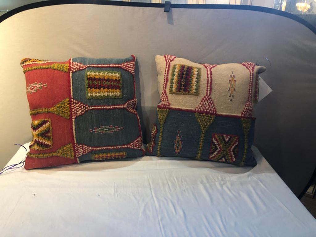 Handwoven tribal wool vintage Kilim cushion or pillow, a pair

This stunning one of a kind pair of Kilim pillows are custom made from a vintage Moroccan wool rug handwoven in the Atlas Mountains in Morocco by Berber women artisans. The pillows