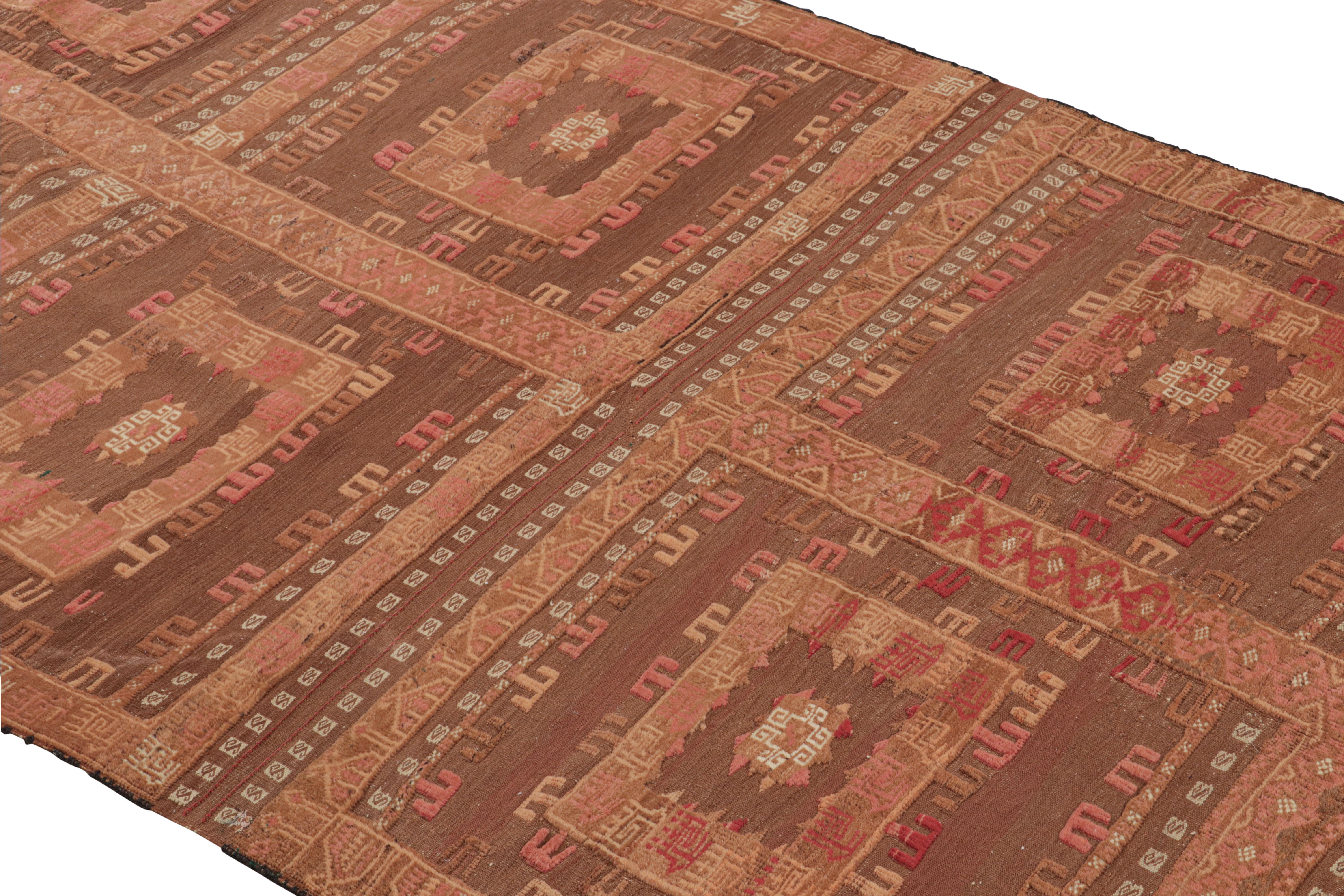 A vintage 4x9 Kilim rug in beige-brown and pink, handwoven in wool originating from Afghanistan circa 1950-1960. Enjoying a unique marriage of pile and flat weave techniques lending a textural, high-low depth to the tribal geometry.

Further on