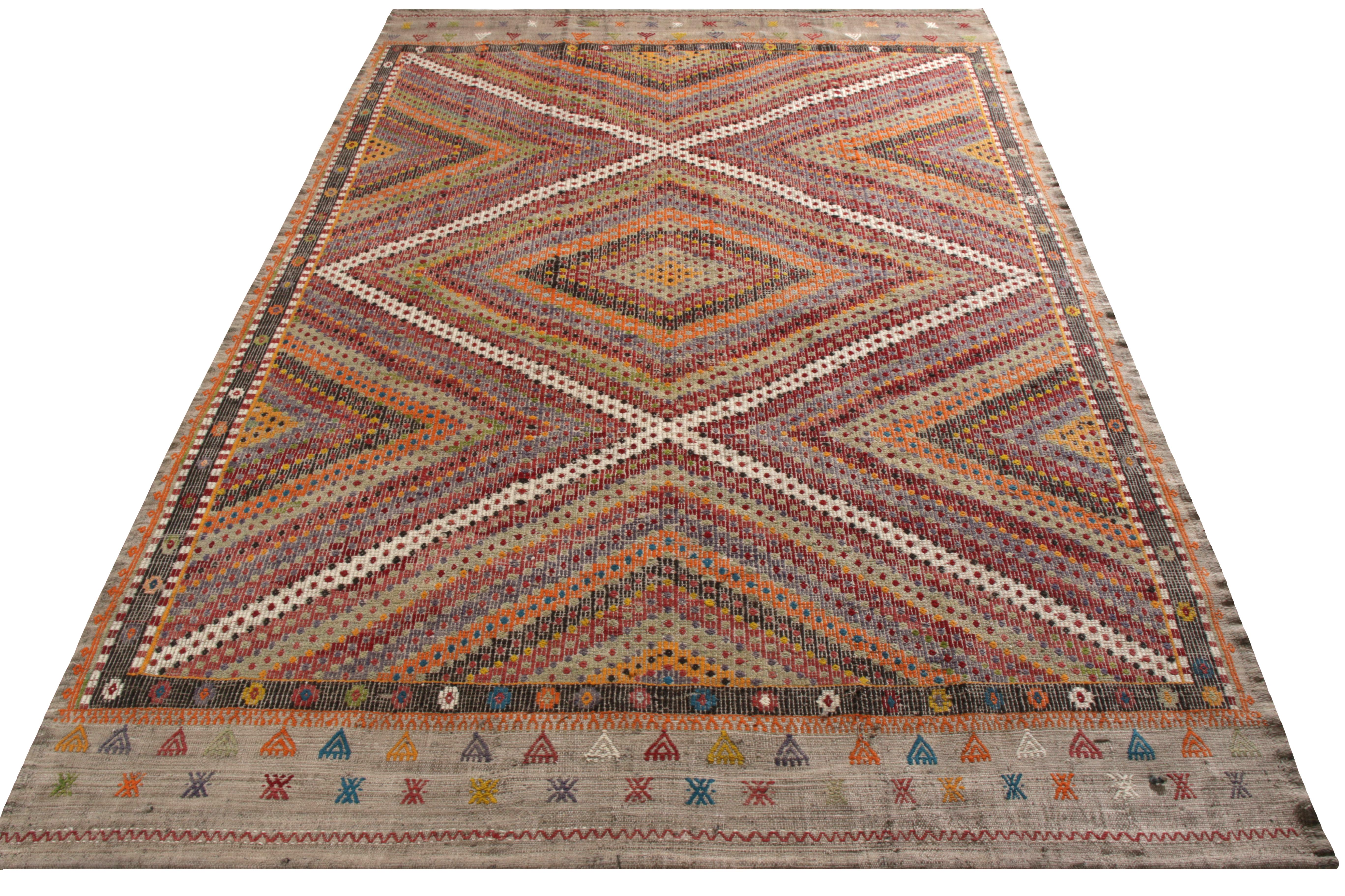 A vintage 6 x 9 Kilim rug of a seldom-seen, high-low embroidery weave—handwoven in wool originating from Turkey, circa 1950-1960. A fabulous marriage of tribal color and geometry with the textural element for a warm, comfortable choice underfoot.