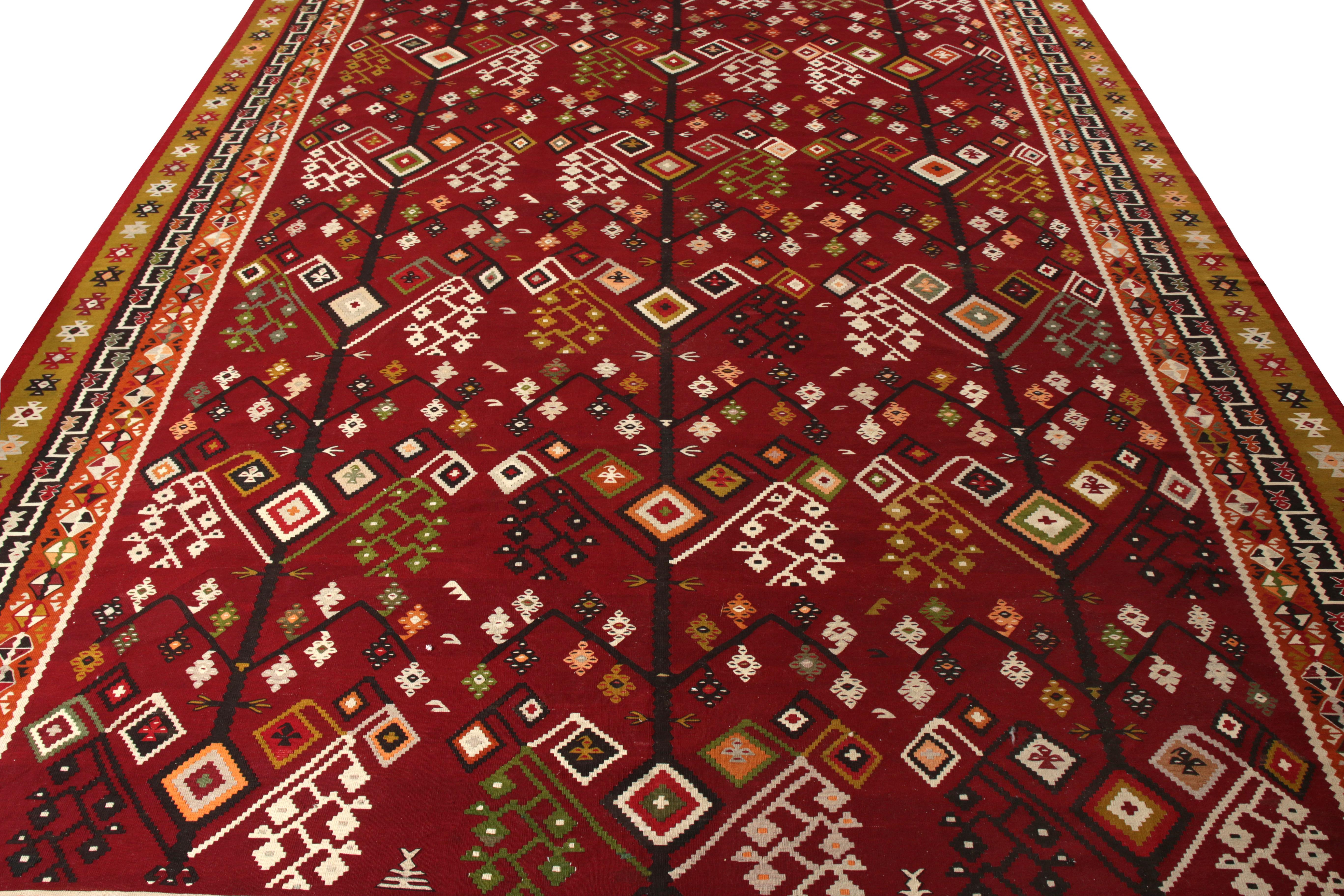 Handwoven in wool originating from Turkey circa 1950–1960, this vintage 12 x 15 Kilim rug enjoys a rare large size for its period and regal mood. An intricate all over design flows lavishly from end to end rejoicing an awe inspiring pattern in a