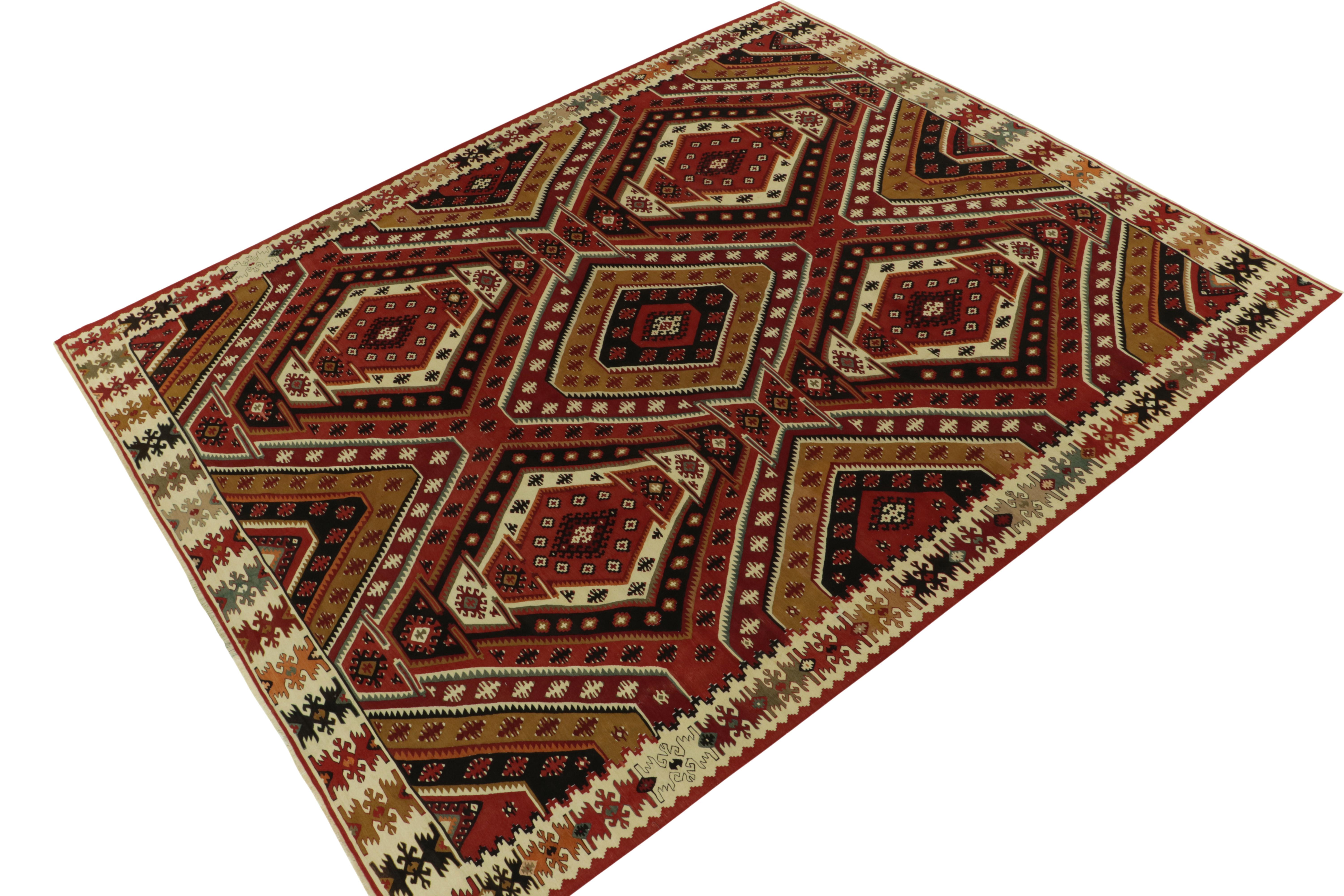 Handwoven in wool originating from Turkey circa 1950-1960, this vintage Kilim rug enjoys a culmination of unique and rare elements in pristine condition, fantastically spacious graph, and a beautiful border enfolding the exemplary midcentury design.