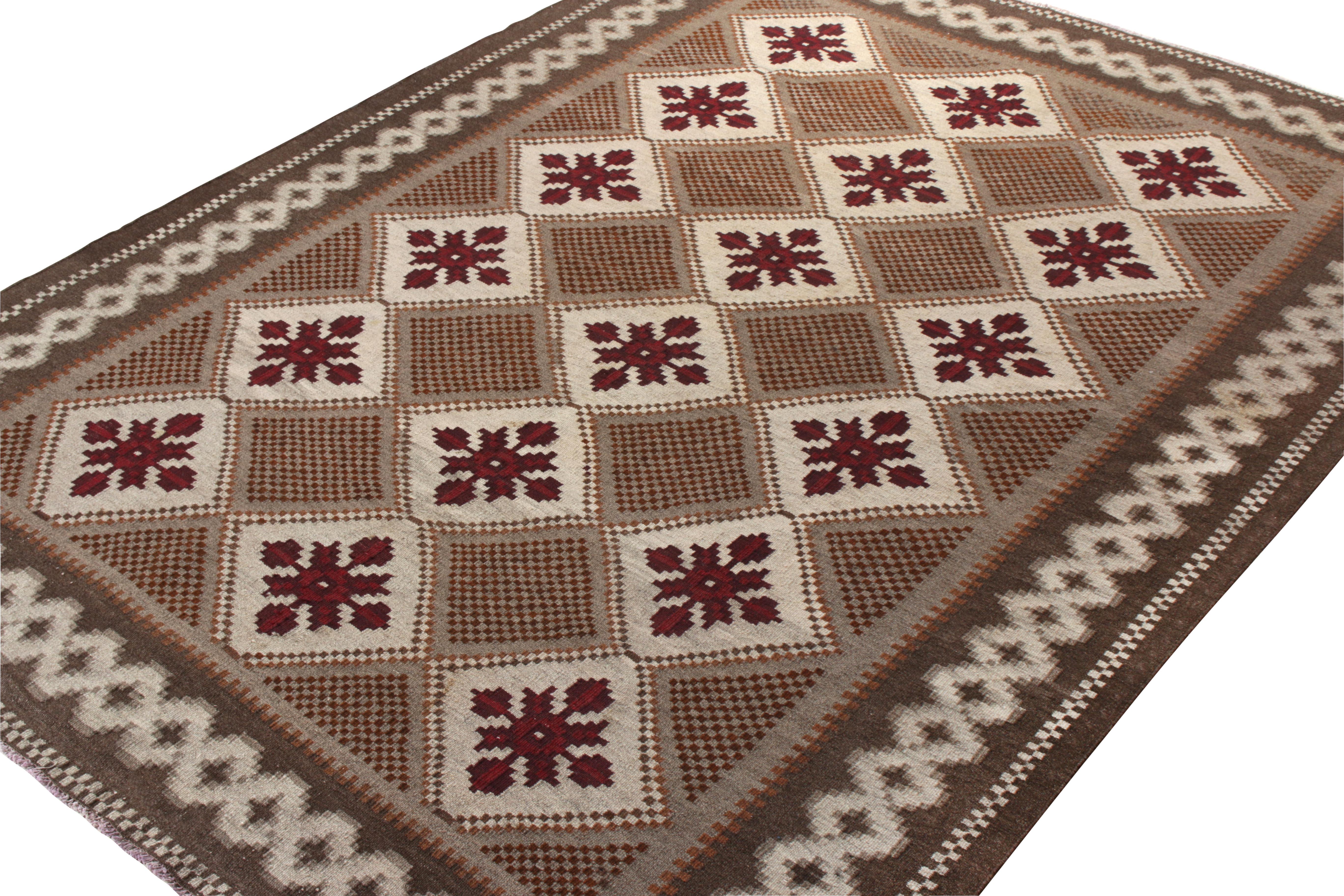 A vintage mid-century Moldavian Kilim originating from Turkey circa 1950-1960, joining Rug & Kilim’s coveted flatweave repertoire. Scaled at 7x9, this uncommon style dons a European garb endowed with floral and geometric patterns in brown,grey and