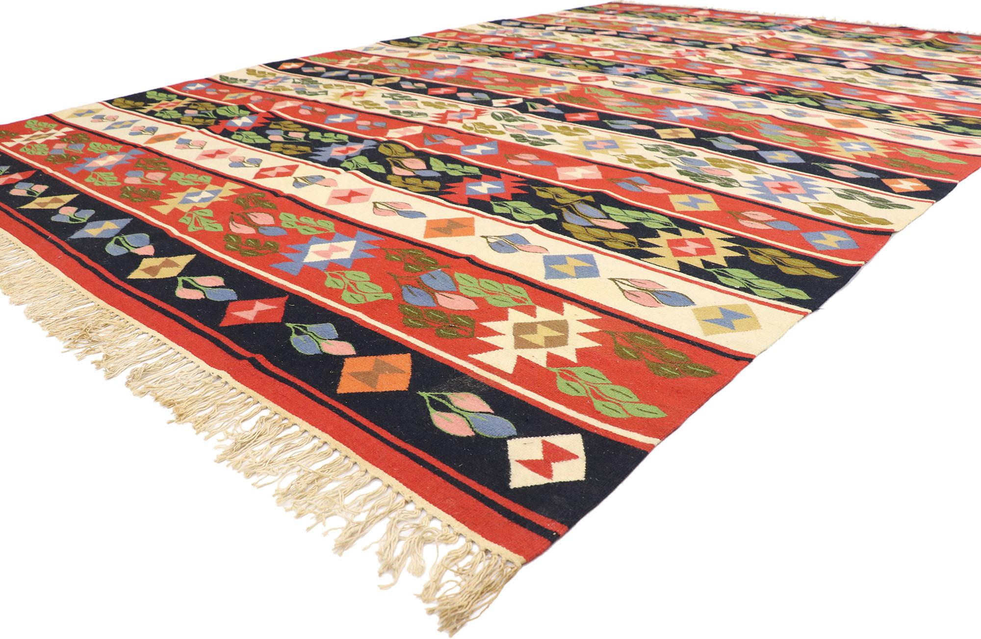 78013 Vintage Romanian Kilim Rug, 08'02 x 12'01. Embark on a captivating journey where the bohemian jungalow aesthetic converges with tribal enchantment in this handwoven wool vintage Romanian kilim rug. The eye-catching botanical design and lively