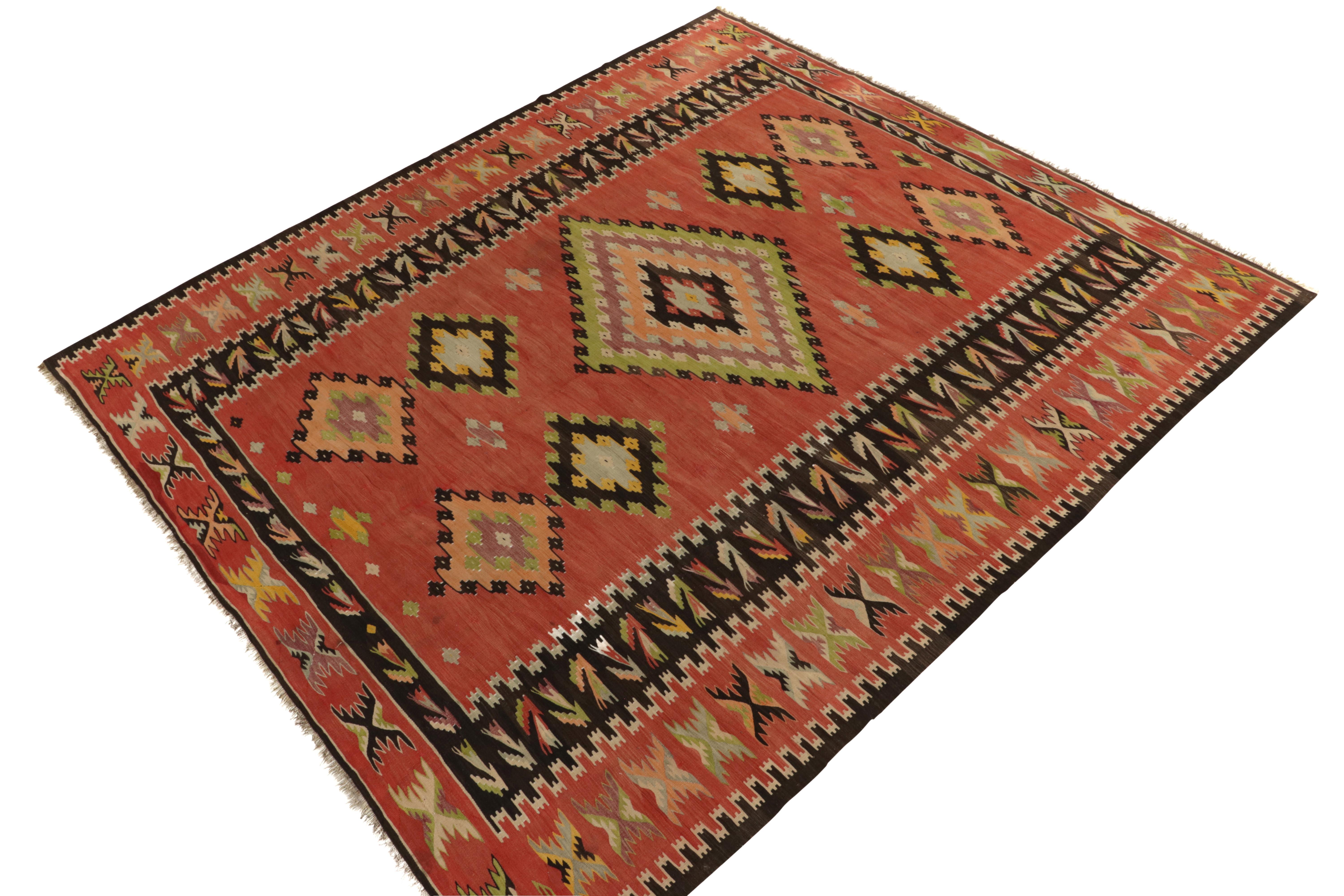 Handwoven in wool originating from Turkey circa 1950-1960, a brilliant 9x11 vintage Kilim rug of outstanding large-size and color. 

On the Design: Among its many accolades, few mid-century flat weaves of this provenance can be found in this