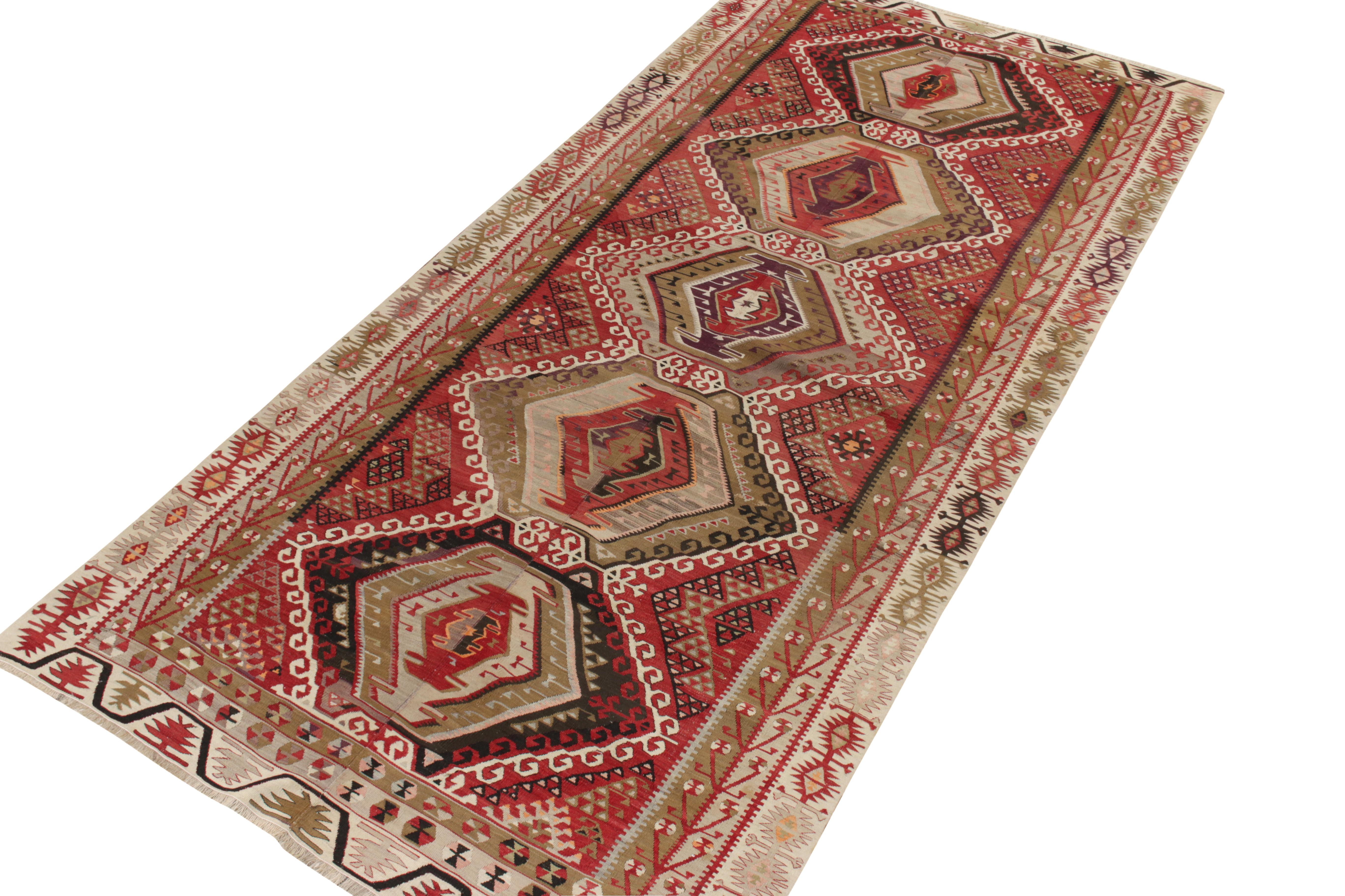 An ode to the Kayseri family of rugs, a 5x11 vintage Kilim in high-quality wool originating from Turkey between 1940-1950 exemplifying the tribal notes of the Anatolian region through tasteful asymmetric variations of the bold red, black, pista