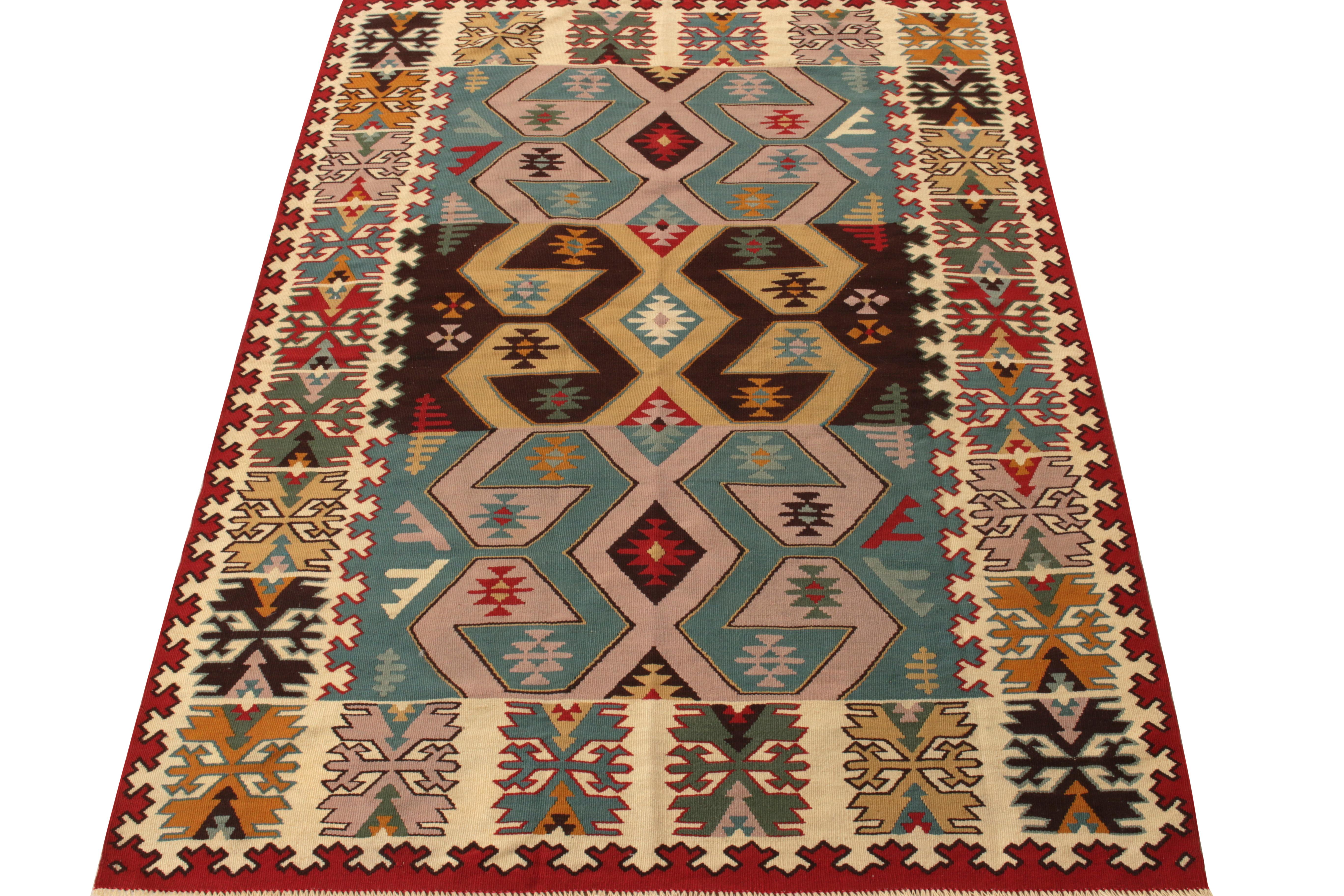 Handwoven in Turkey circa 1950-1960, an expressive vintage flatweave rug enjoying nomadic sensibilities entering our Kilim & Flatweave collection. The field features a tribal geometric pattern in bright kaleidoscopic shades sitting comfortably in