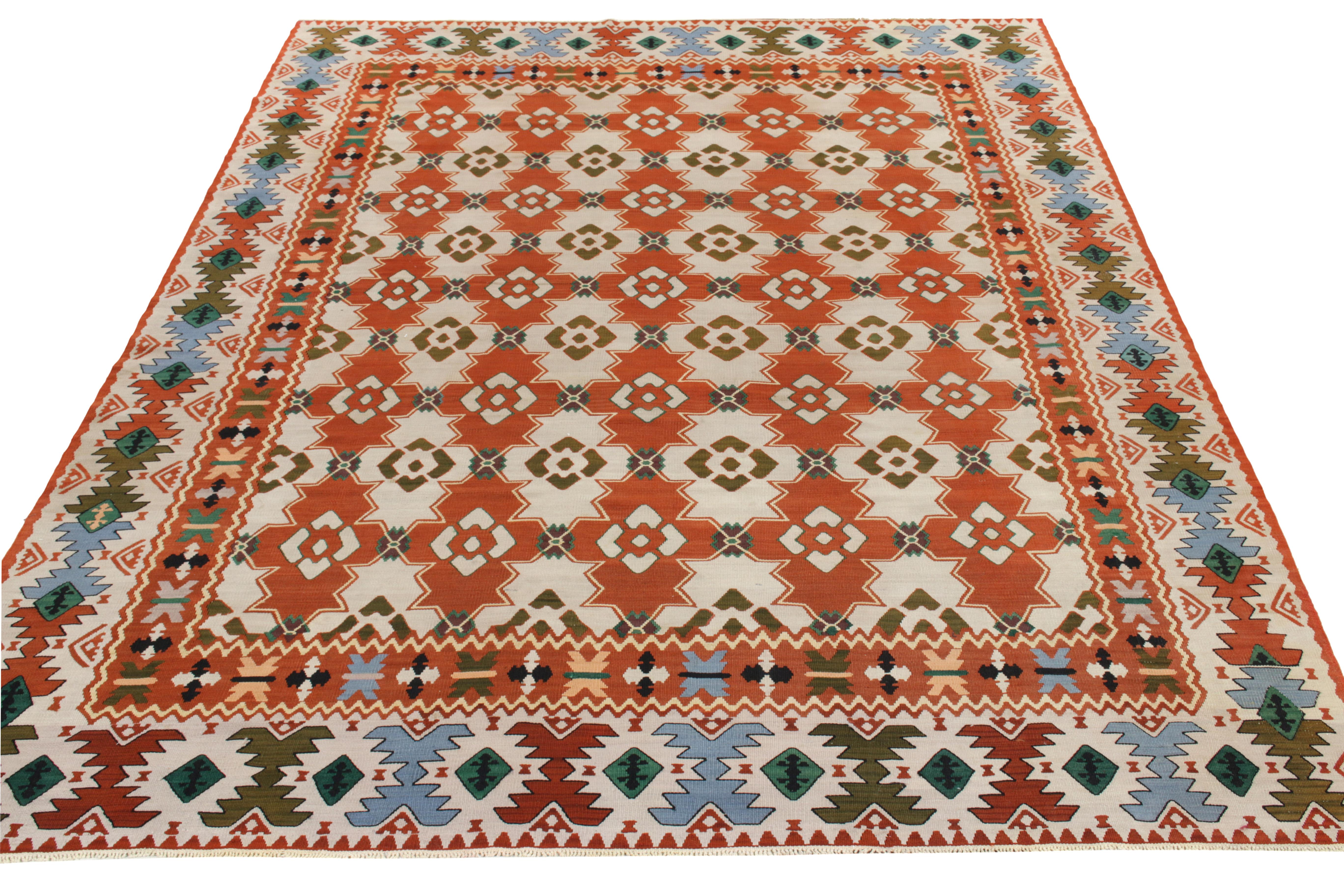 Handwoven in Turkey circa 1950-1960, a vibrant vintage flatweave rug enjoying nomadic sensibilities—entering our coveted Kilim & Flatweave collection. The field features a tribal geometric pattern in bright tangerine & stark white sitting