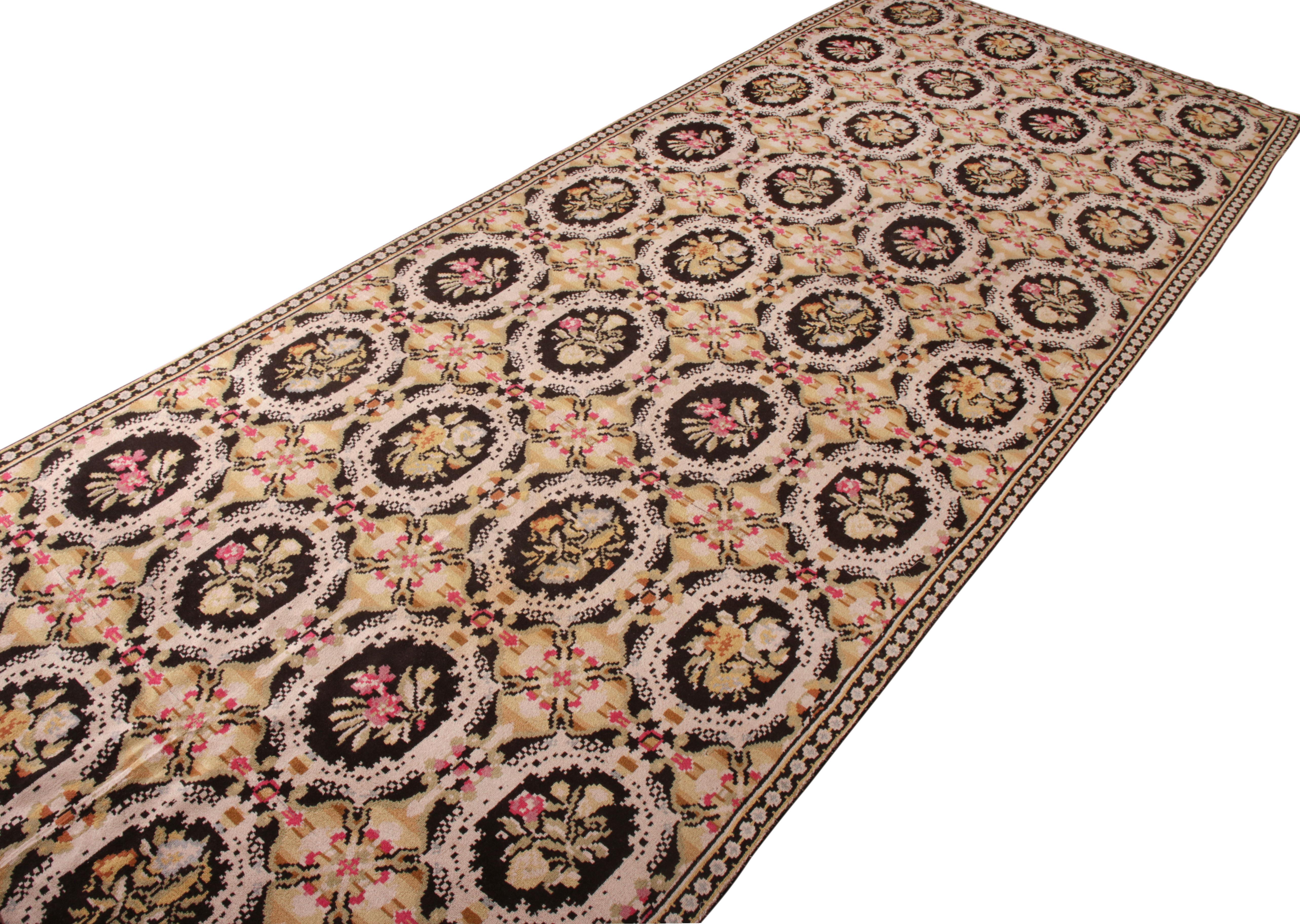 Handwoven in the United States circa 1950-1960, this large size vintage wilton carpet is an ode to the idyllic European style. Handwoven in wool in a phenomenal 8 x 27 size uncommon to its line, the piece makes the most of the frame with an all over