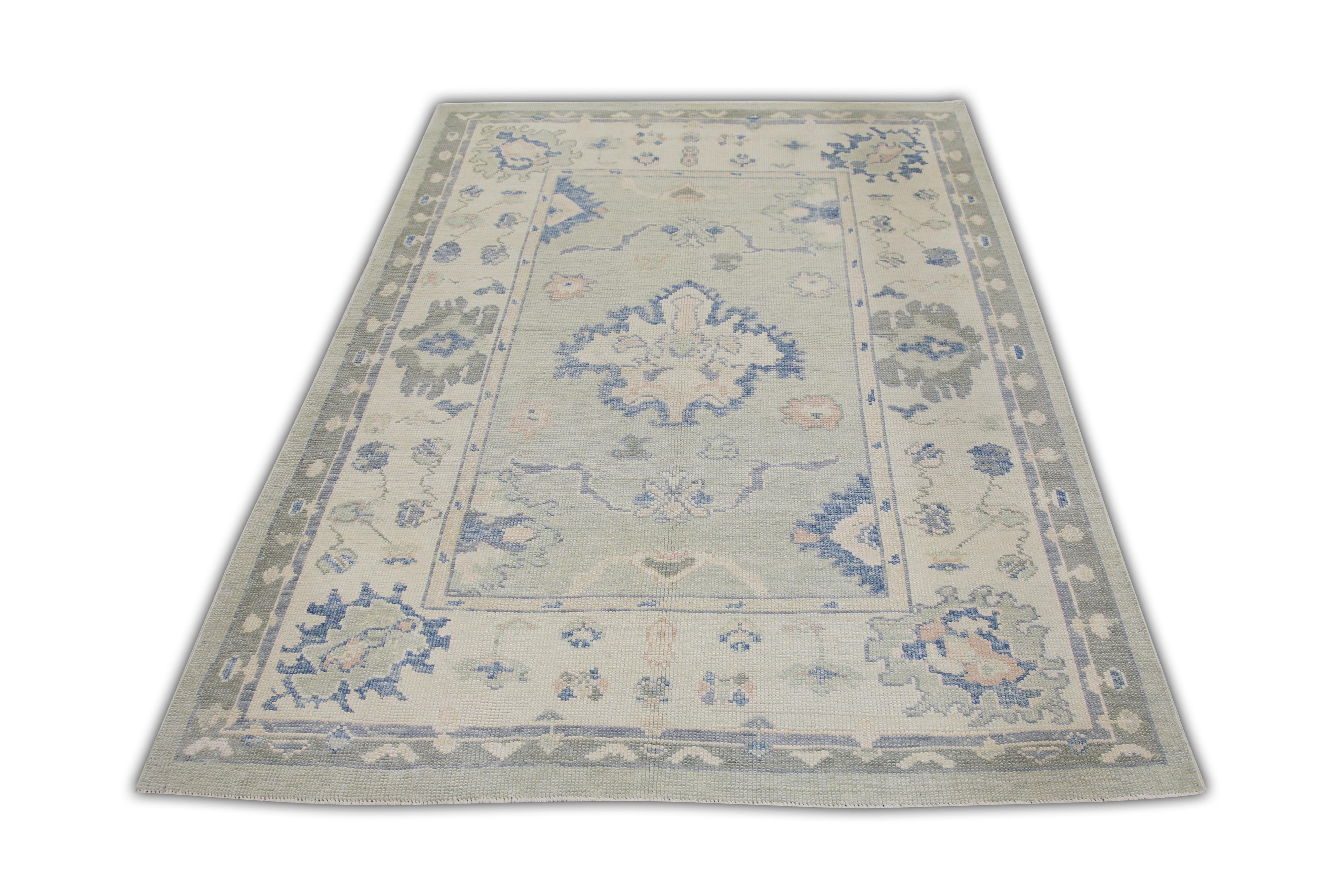 This Turkish oushak rug is a stunning piece of art that has been handwoven using traditional techniques by skilled artisans. The rug features intricate patterns and a soft color palette that is achieved through the use of natural vegetable