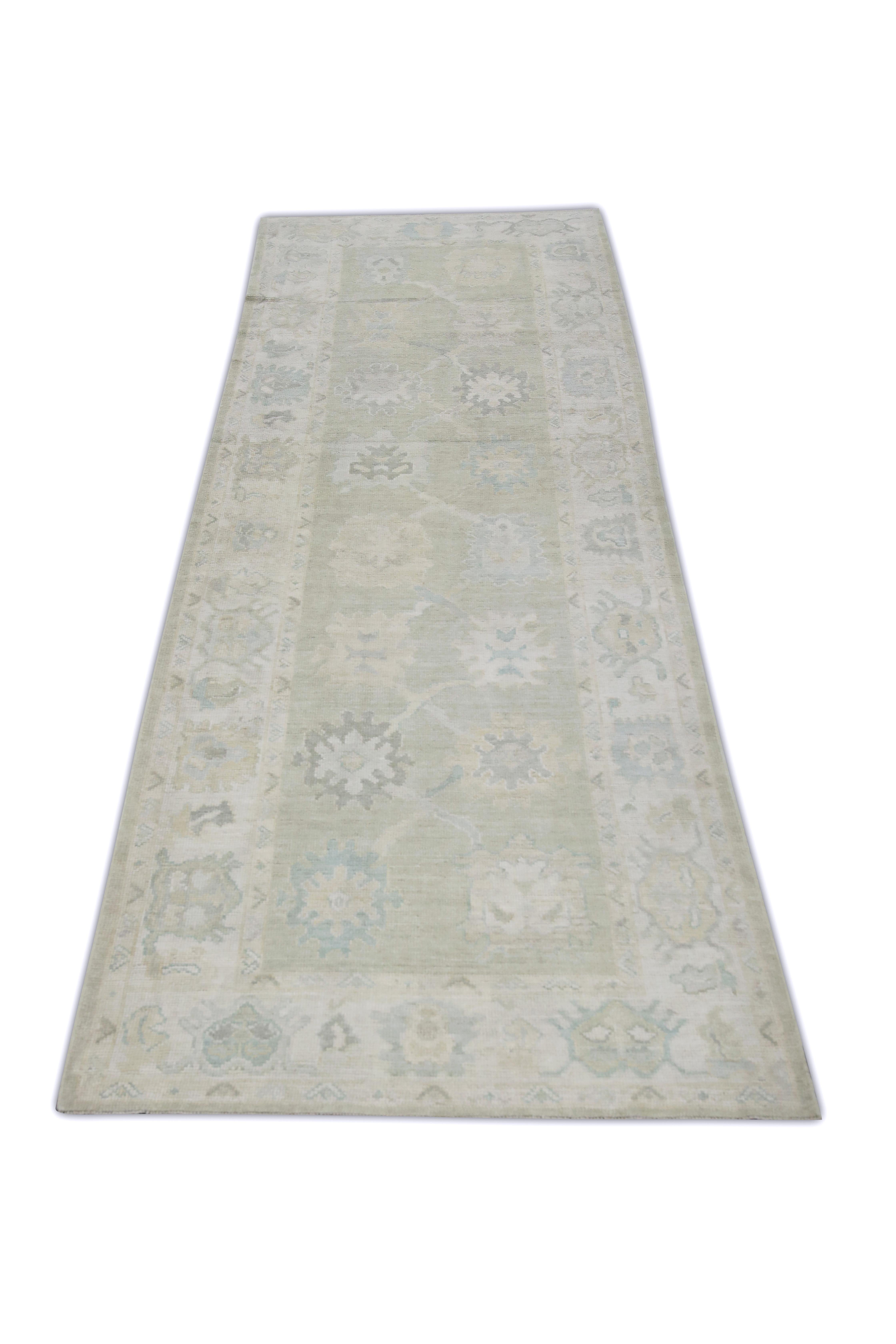 This Turkish oushak rug is a stunning piece of art that has been handwoven using traditional techniques by skilled artisans. The rug features intricate patterns and a soft color palette that is achieved through the use of natural vegetable