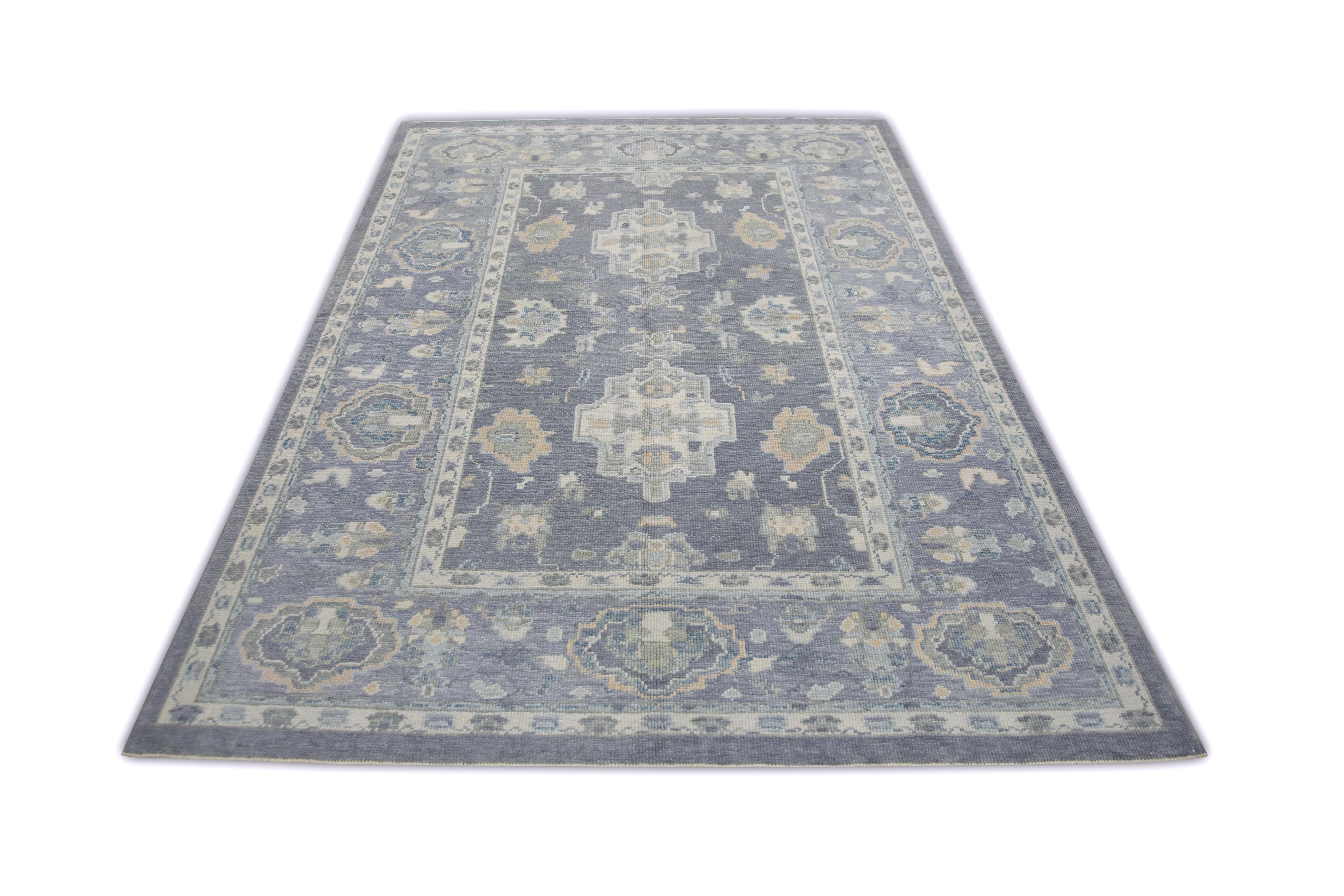 This Turkish oushak rug is a stunning piece of art that has been handwoven using traditional techniques by skilled artisans. The rug features intricate patterns and a soft color palette that is achieved through the use of natural vegetable