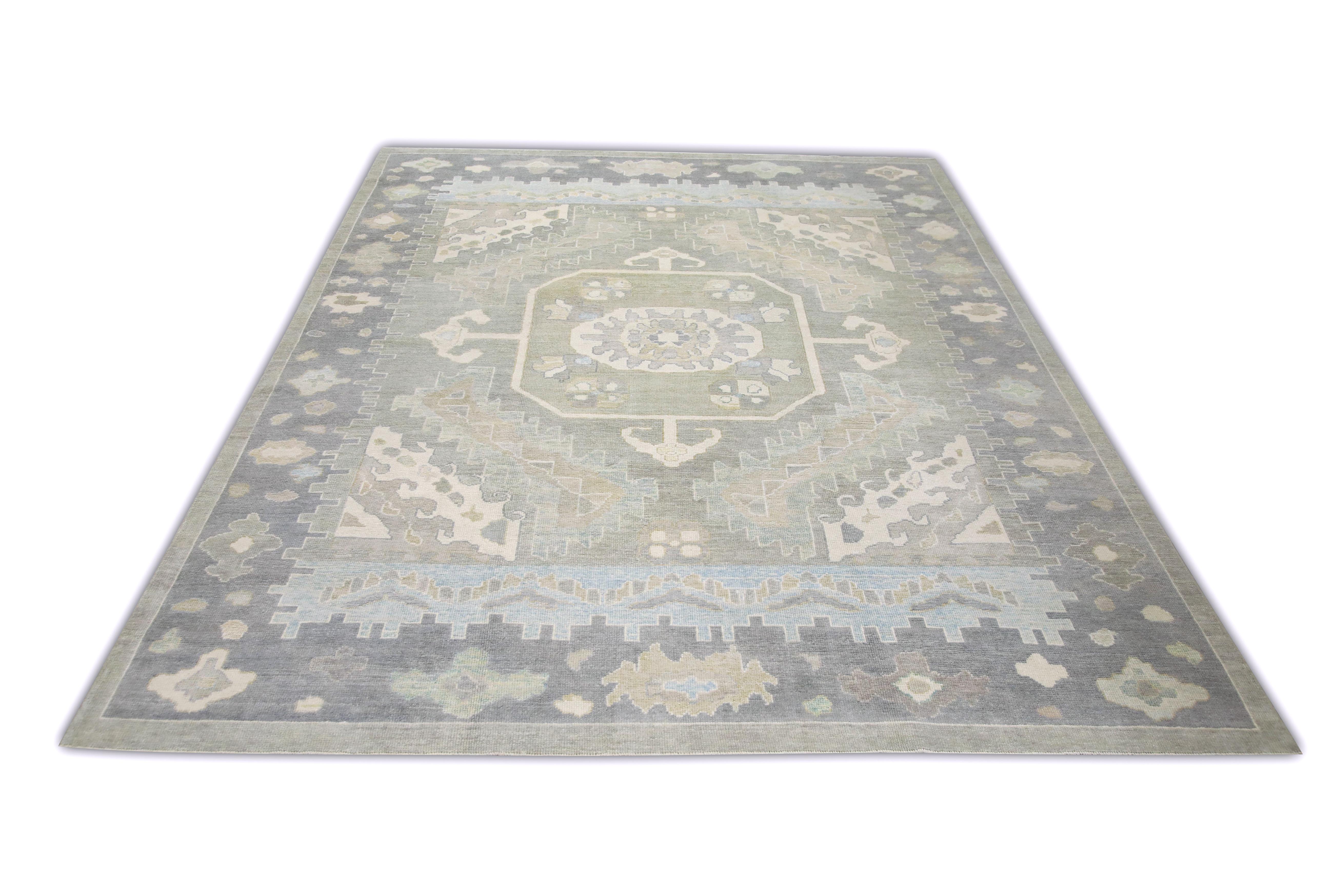 This Turkish oushak rug is a stunning piece of art that has been handwoven using traditional techniques by skilled artisans. The rug features intricate patterns and a soft color palette that is achieved through the use of natural vegetable