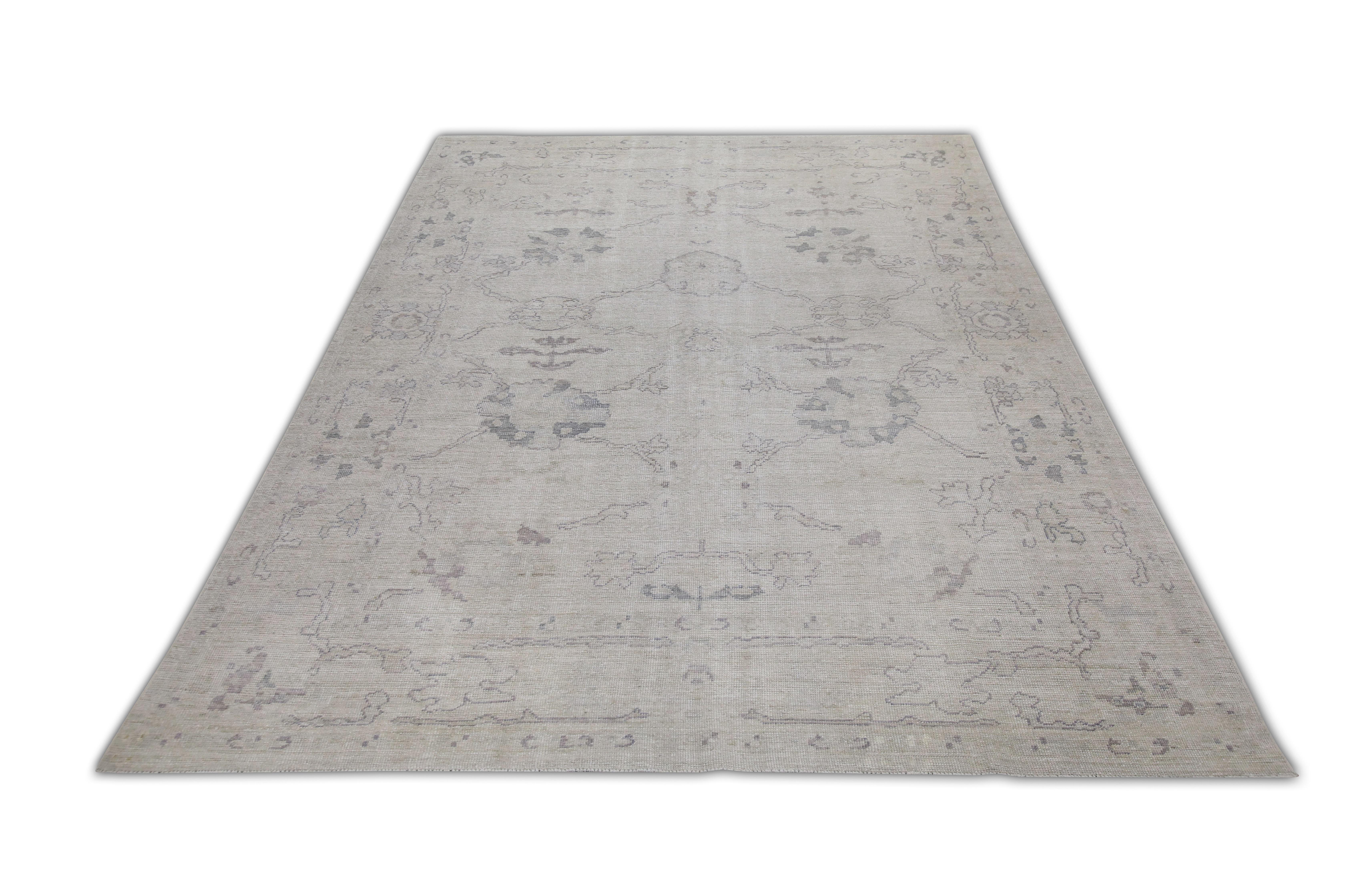 This Turkish oushak rug is a stunning piece of art that has been handwoven using traditional techniques by skilled artisans. The rug features intricate patterns and a soft color palette that is achieved through the use of natural vegetable