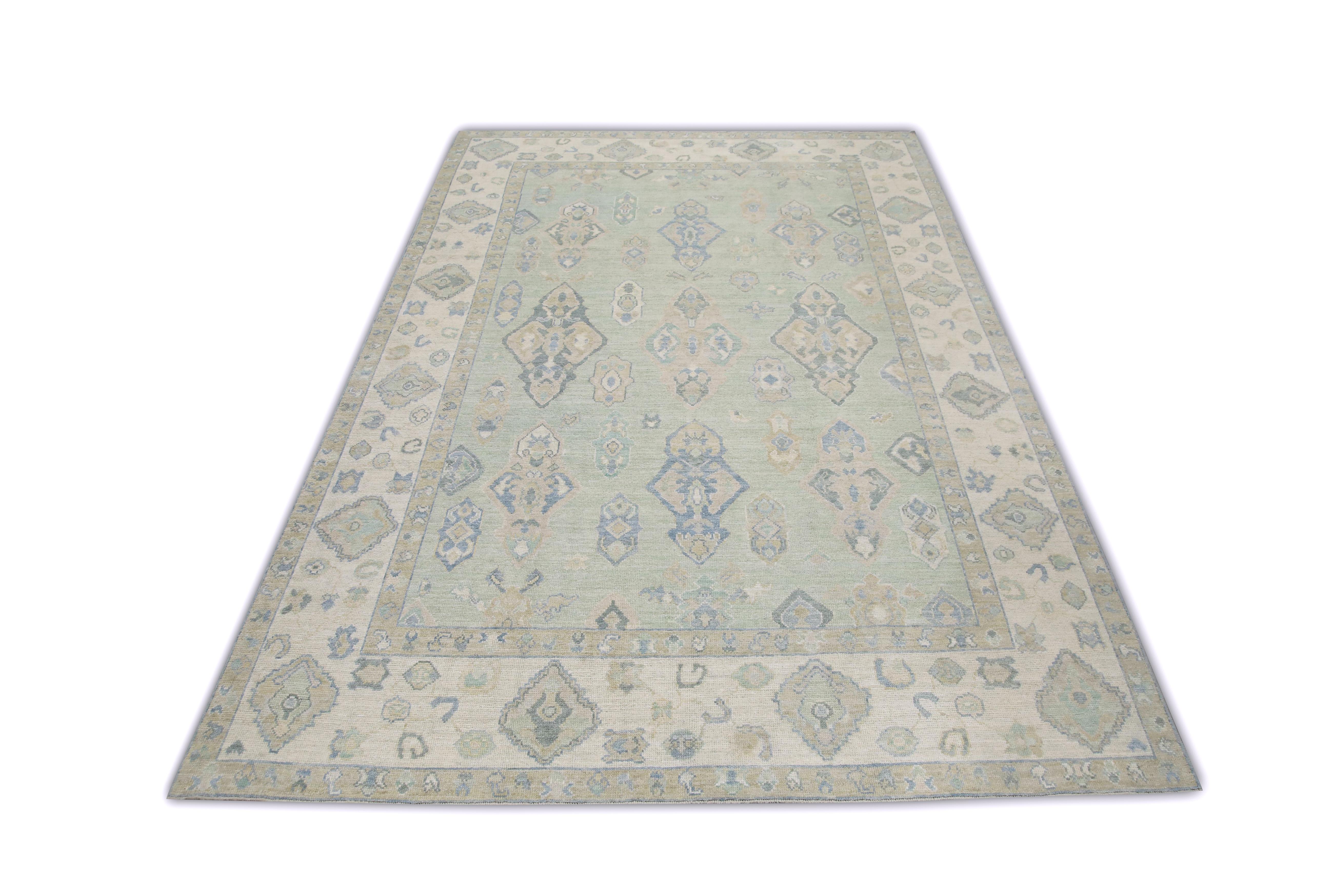 This Turkish oushak rug is a stunning piece of art that has been handwoven using traditional techniques by skilled artisans. The rug features intricate patterns and a soft color palette that is achieved through the use of natural vegetable