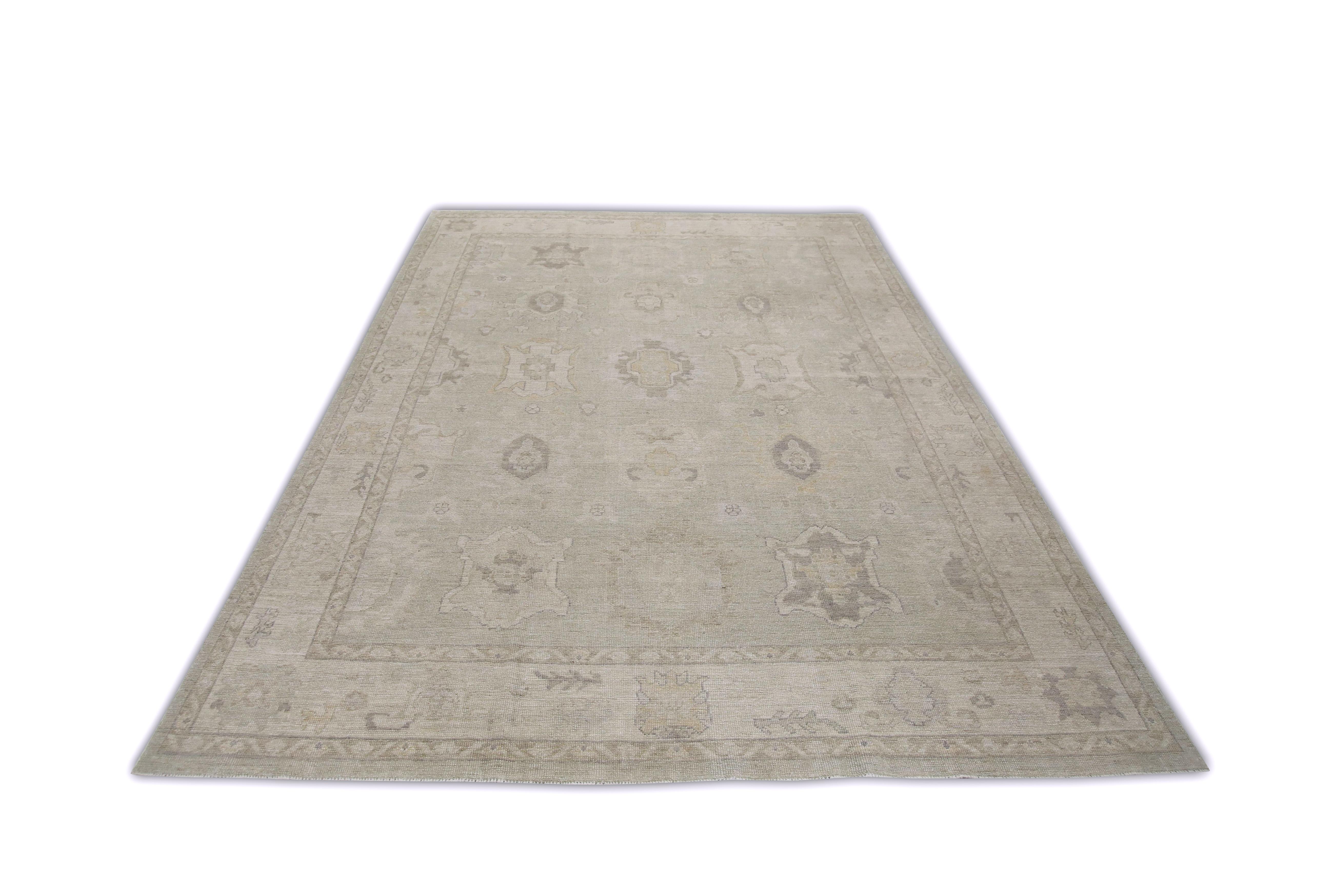 This Turkish oushak rug is a stunning piece of art that has been handwoven using traditional techniques by skilled artisans. The rug features intricate patterns and a soft color palette that is achieved through the use of natural vegetable