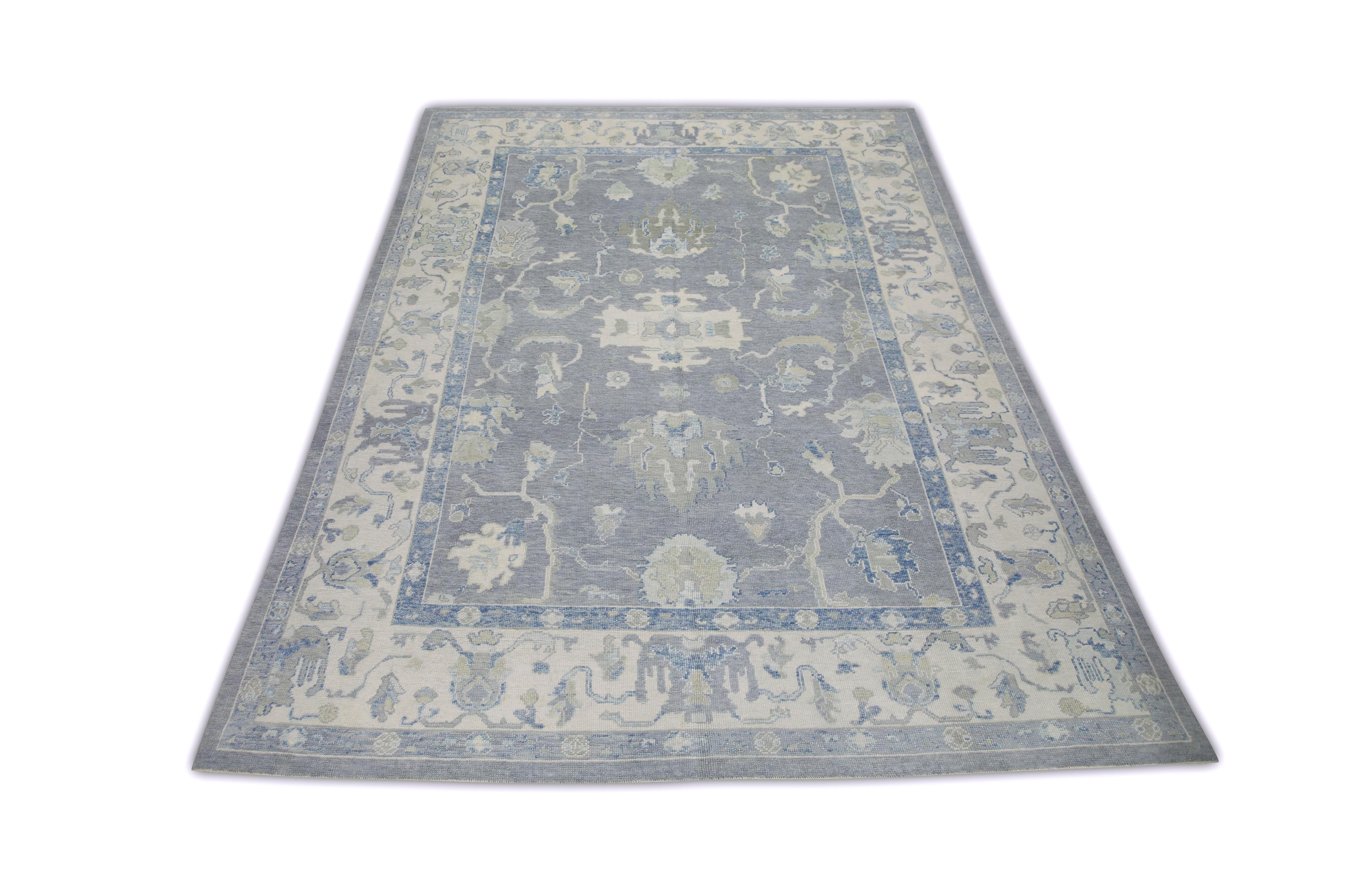 This Turkish oushak rug is a stunning piece of art that has been handwoven using traditional techniques by skilled artisans. The rug features intricate patterns and a soft color palette that is achieved through the use of natural vegetable