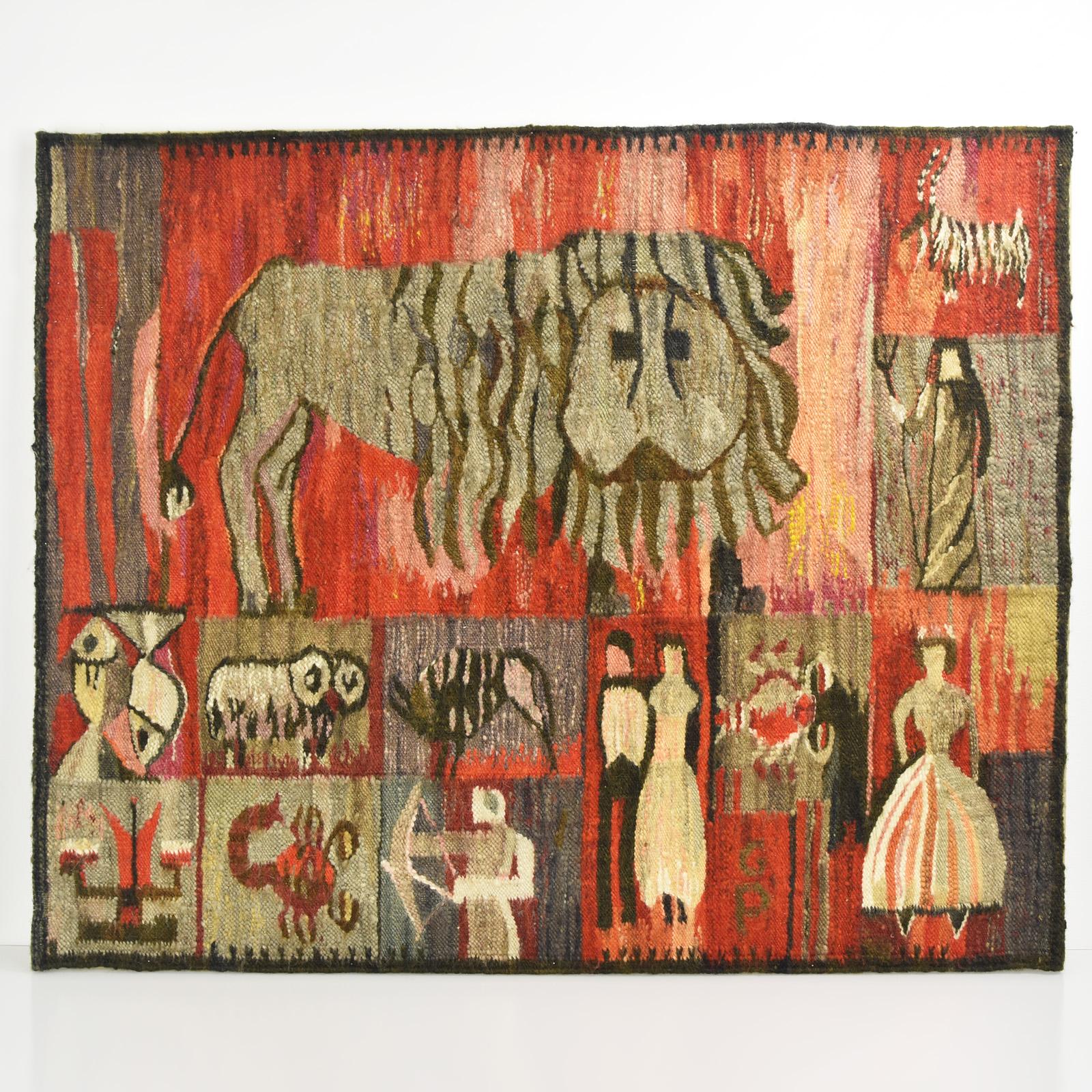This vibrant handwoven mid-century Gobelin tapestry features a bold, abstract depiction of zodiac-inspired motifs by Piotr Grabowski. 

Highlighted at the center is a stylized lion surrounded by a variety of symbolic figures and intricate imagery.