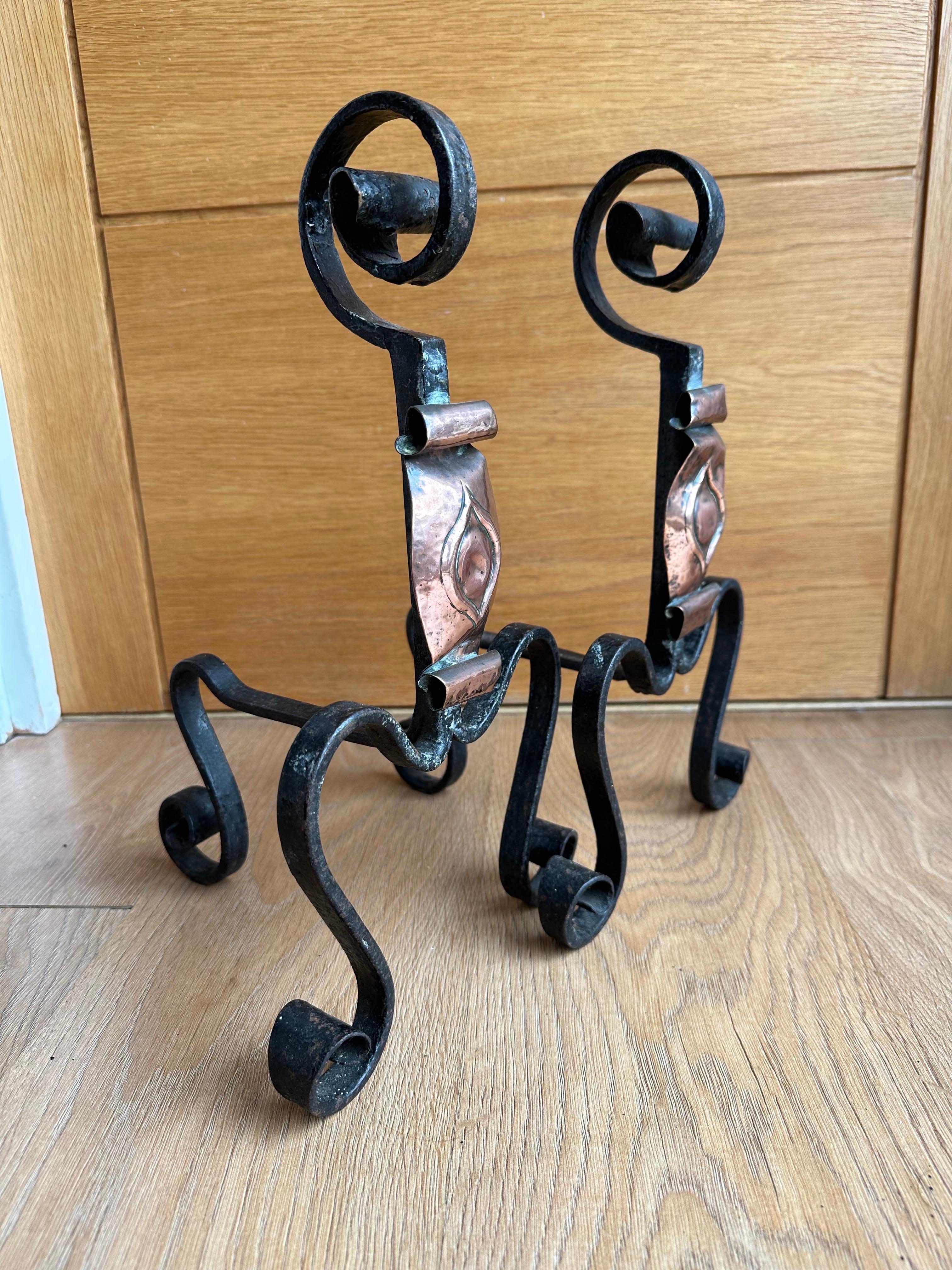 A beautiful pair of Handwrought Iron and Copper Gothic Fireplace Andirons Firedogs, 19th Century. This pair are completely wrought by hand out of very thick iron and have a dark black finish, crafted with swirled legs and shafts with beautifully
