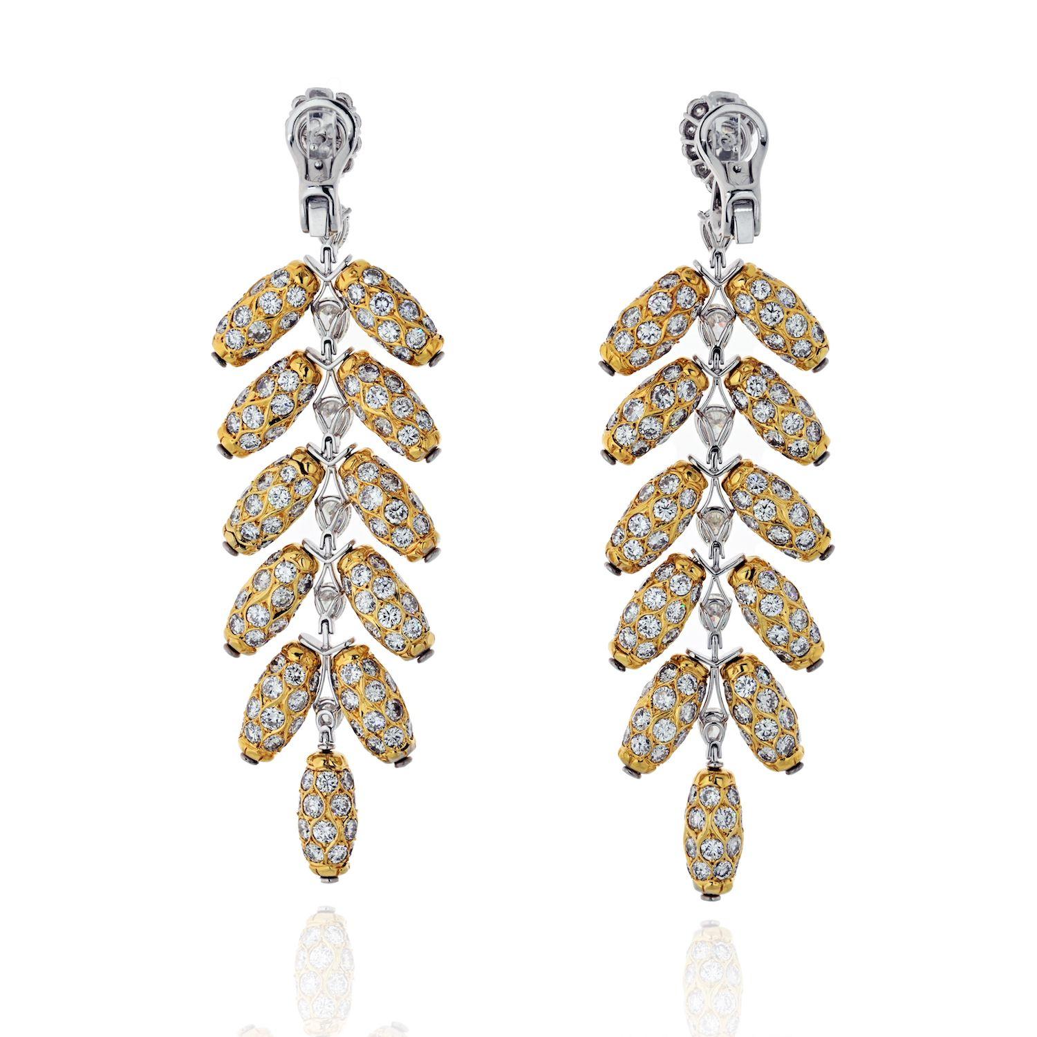 From our Estate Collection. A free-spirited creation dramatic pendant feather earrings capture the beauty and all the glam of the peacock's feather motif in intricately detailed 18K yellow gold diamond jewel. These earrings feature 2 diamonds of