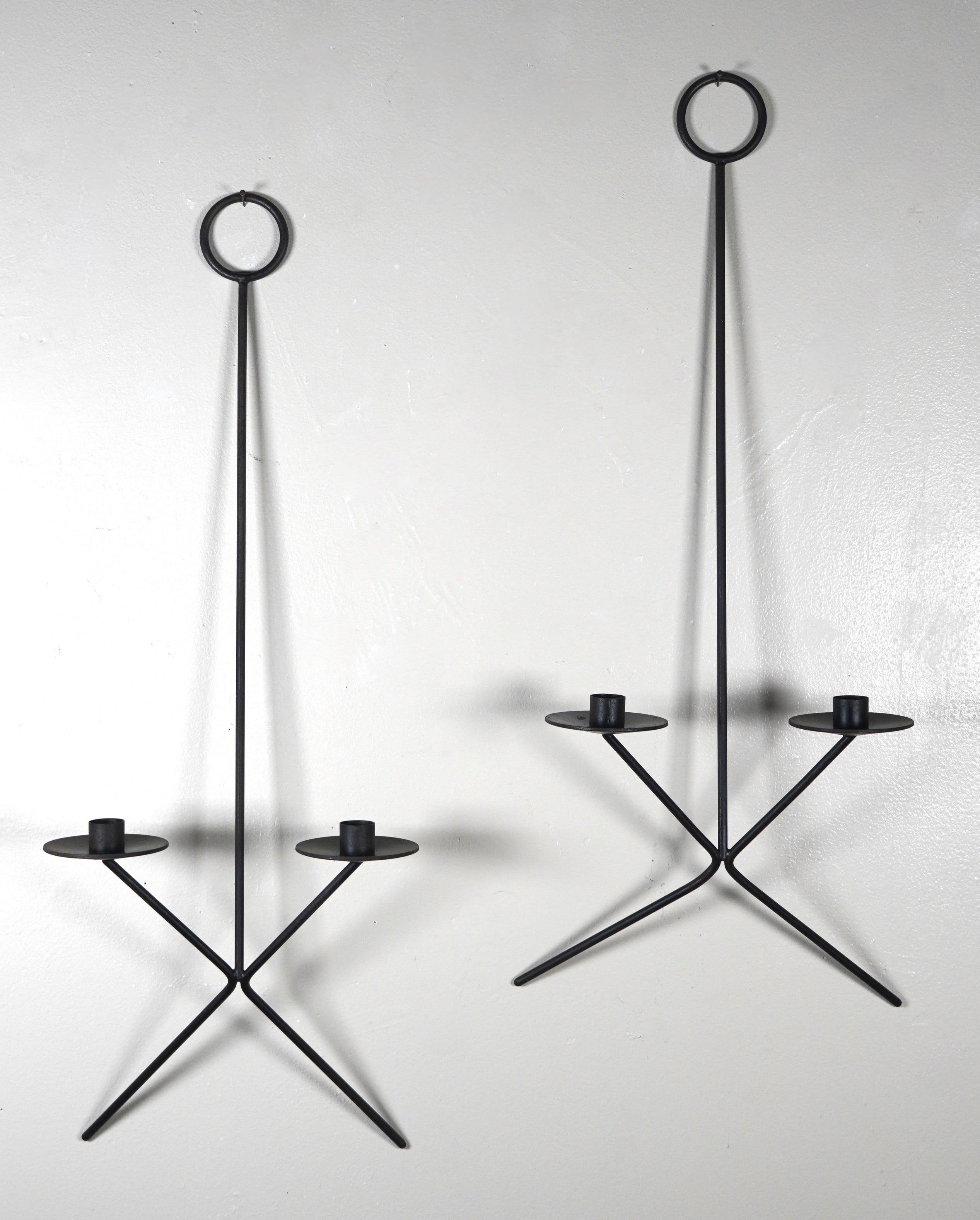 1950s Modernist hanging candle holders / sconces, a very clean and architectural design that looks great with or without candles. A striking design on a open wall either inside or out. Constructed of welded steel painted black.