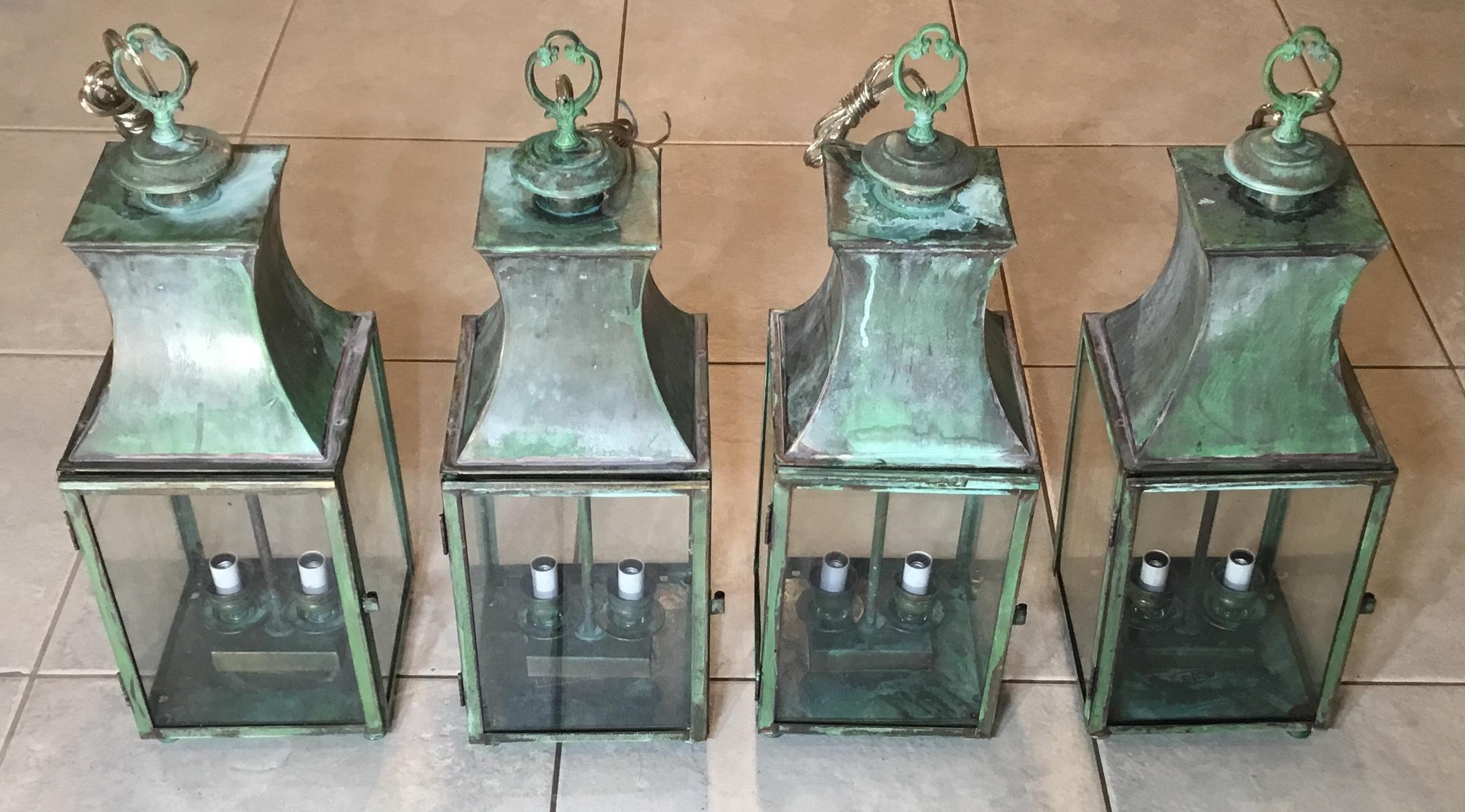 Elagent hanging lanterns made of solid brass, with two 60 watt lights each, suitable for wet locations ready to use, great oxidized patina and four decorative foots at the bottom of the lantern.
Brass canopy and chain included. Could buy single or