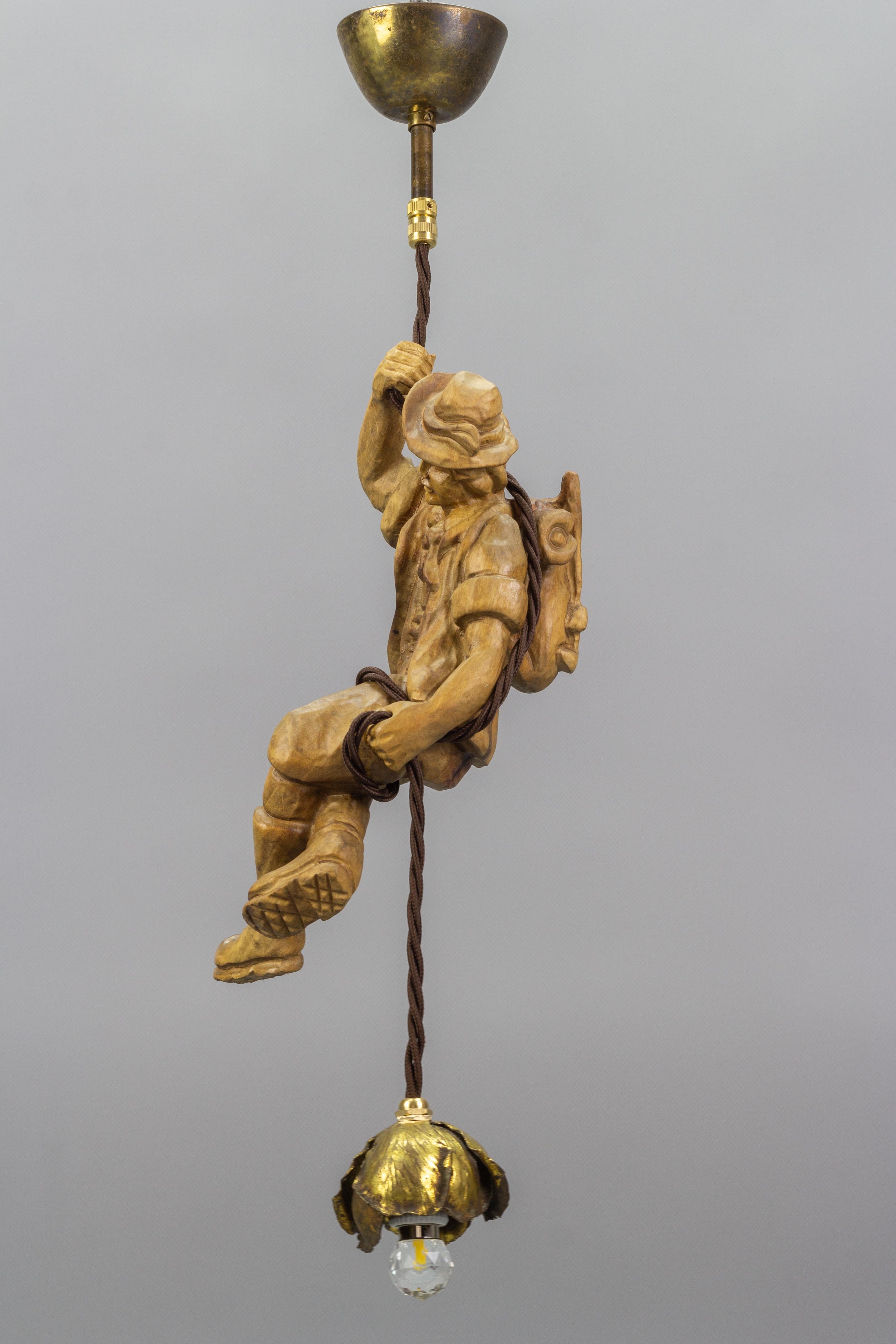 Hand-Carved Hanging Brass Light Fixture with a Wooden Figure of a Mountain Climber For Sale