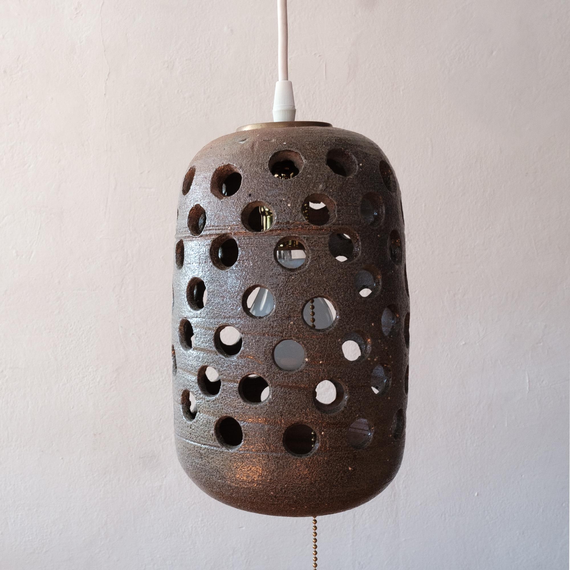 Hanging ceramic pendant lamp from the 1960s. This lamp hung at the estate of ceramic artist and Mingei Museum founder, Martha Longenecker. The estate included work by Longenecker and many ceramics by Japanese ceramicists. This piece is unsigned.