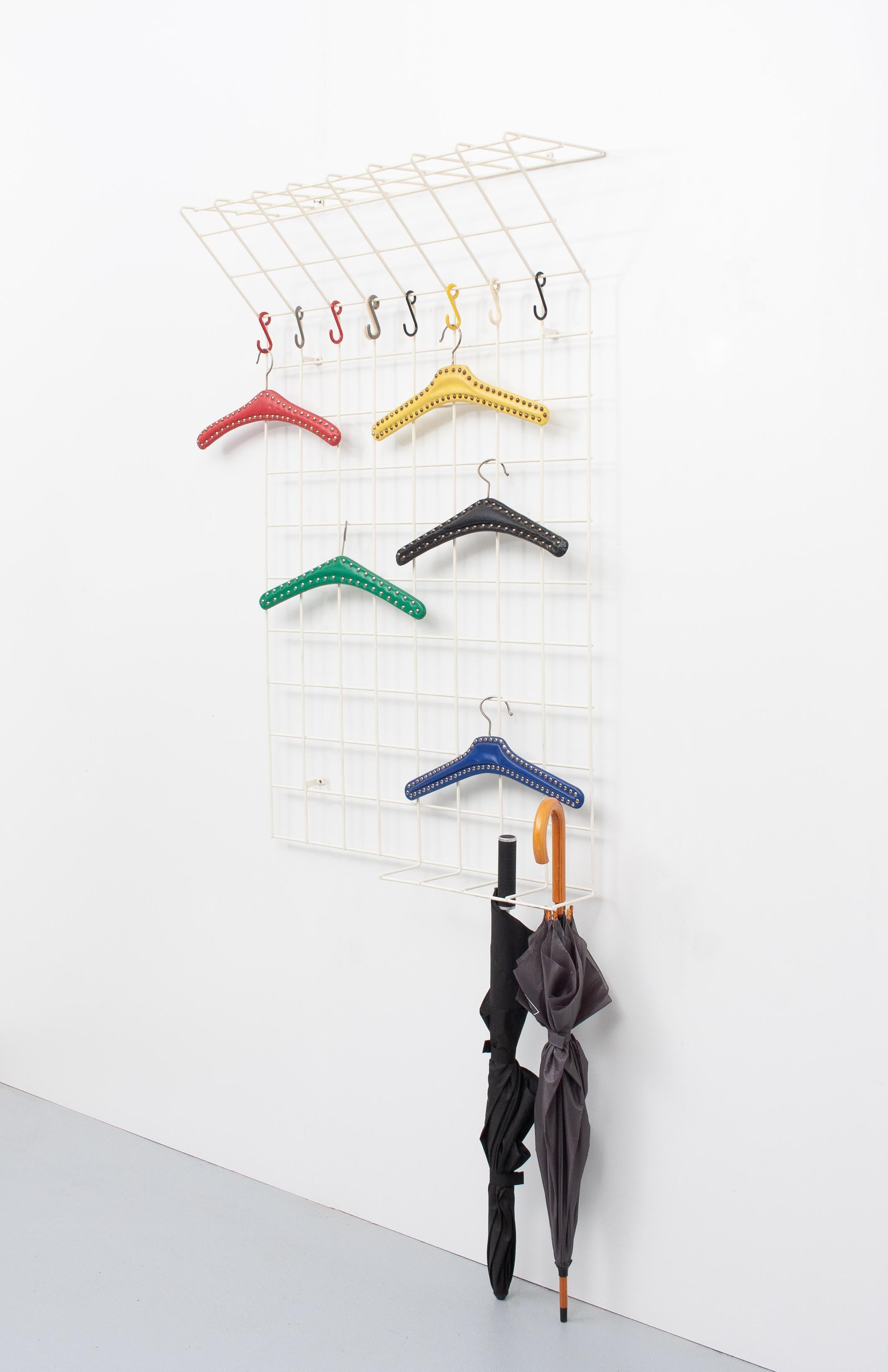Designed by Karl Fichtel, around 1955, for wire works in Erlau. Reduced construction made of metal filaments encased in white plastic with adjustable, multi-colored coat hooks. Height approx. 120 cm, width approx. 80 cm, depth approx. 24 cm. Slight