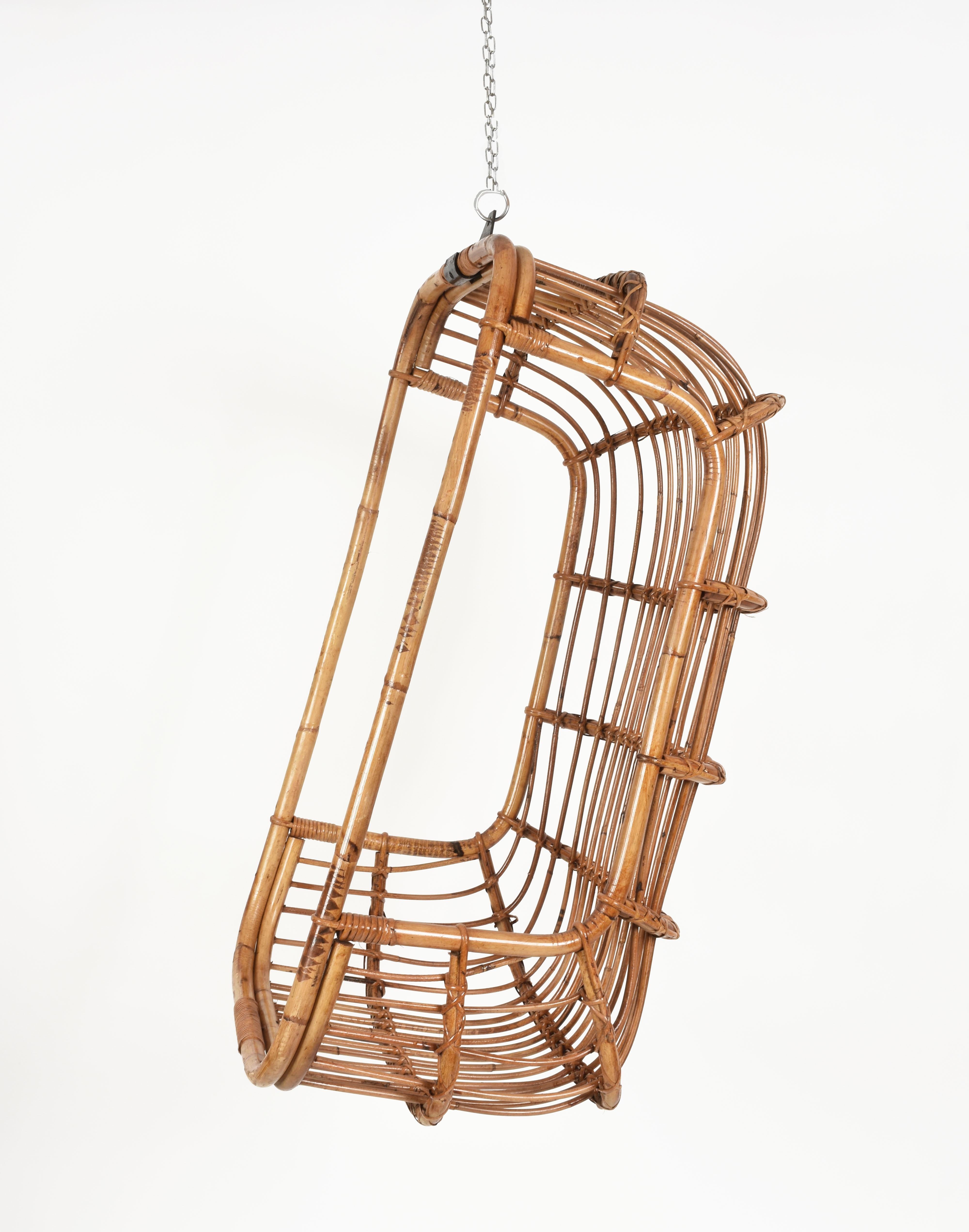 Unique hanging eggshaped midcentury rattan and bamboo armchair. This amazing piece was produced in Italy in 1970s.

This piece is incredible as not only has the egg shape, a typical theme of the design from 1970s, but it hanging from the ceiling