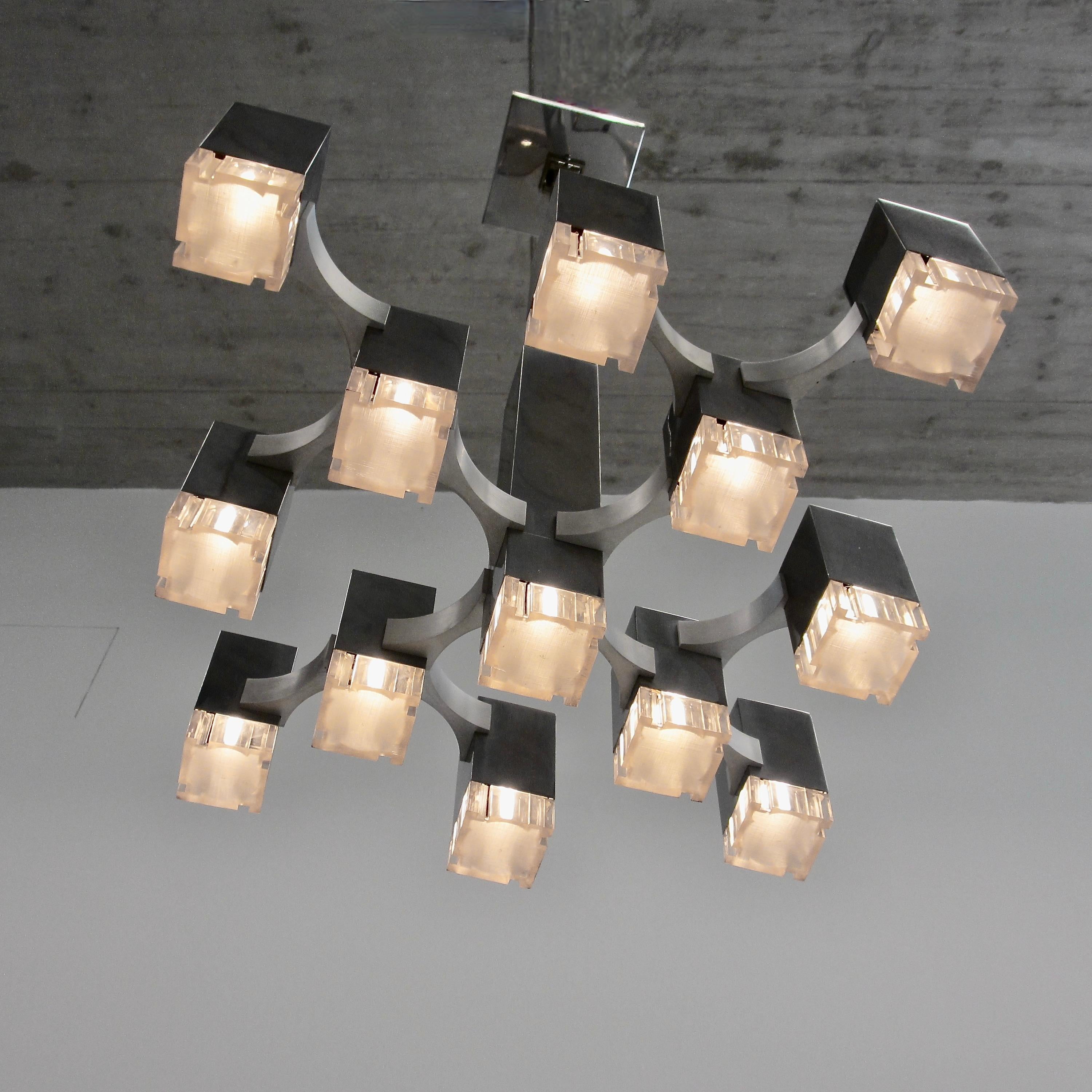 Early nickel plated ceiling light designed by Gaetano Sciolari. Italy, Sciolari, 1970s.

The CUBIC ceiling lamp with 13 light fittings, nickel-plated frame, plexiglass diffusers, designed and produced by Sciolari.

While the company 