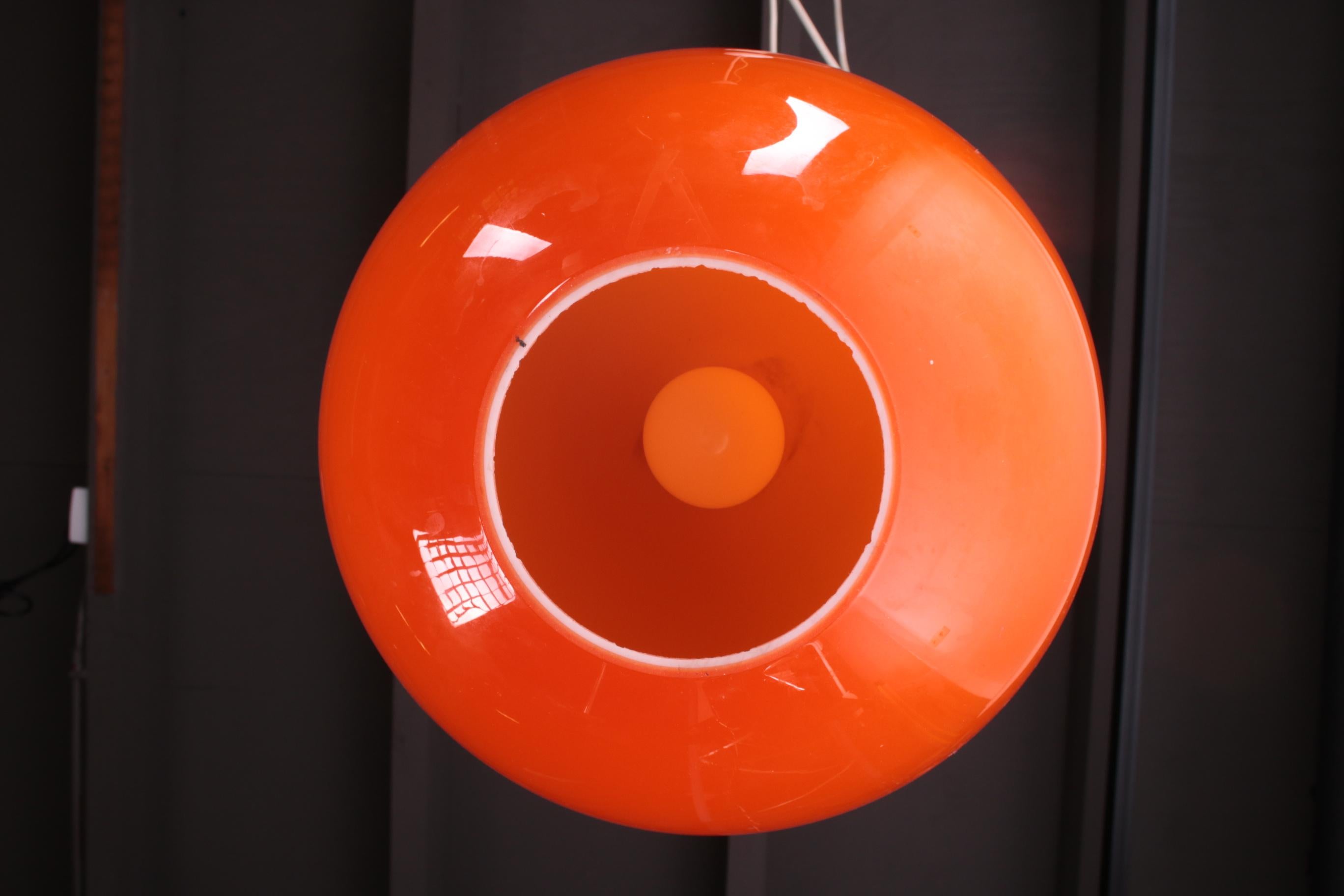 Beautiful orange hanging lamp, this model is also called Ui. (The shape of an Onion). These lamps are mouth blown and this is also called Murano glass. The inside is always white. This lamp unfortunately no longer has stickers of