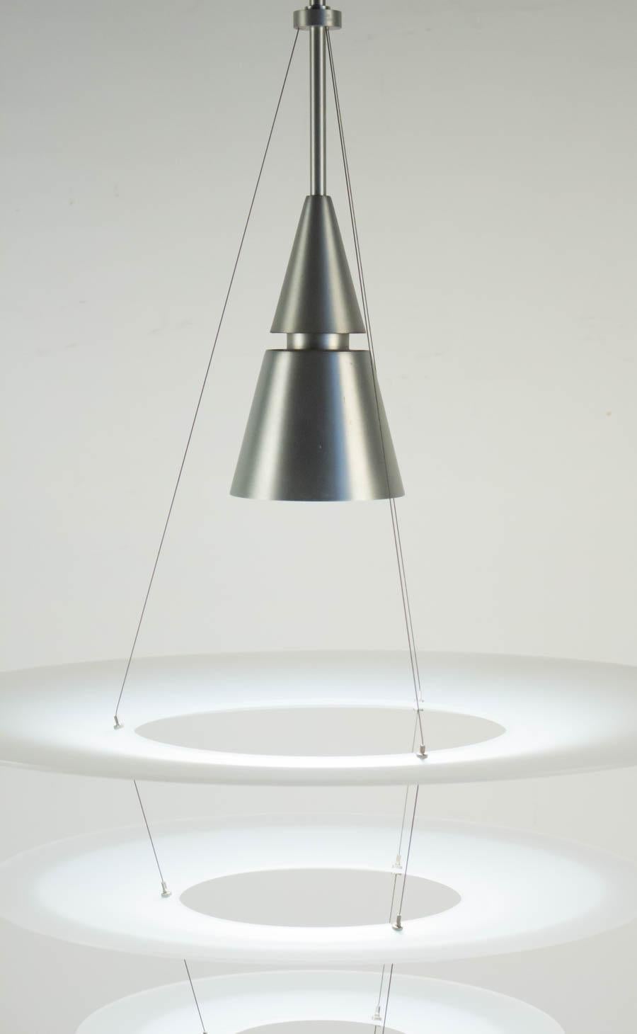 Hanging light fixture, contemporary, from the house of Louis Poulsen, designed by Shoichi Uchiyama, brushed aluminum and acrylique. 
Measures: H 110cm, D 55cm.