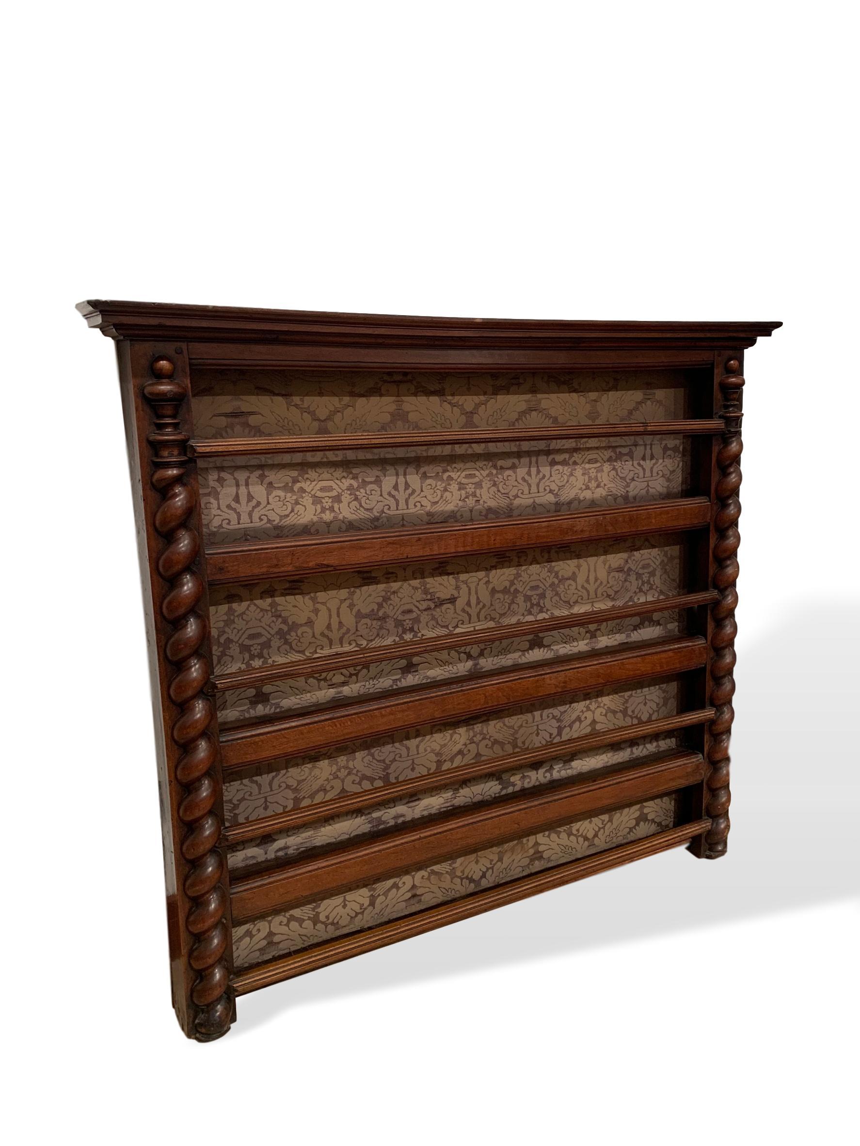 Hanging plate rack, walnut, with barley twist columns, french, circa 1870. Fabric on back can be easily replaced to suit. Beautifully carved with a warm patina. In very good antique condition with no damage. Ready to hang.

Measurements: 50.5